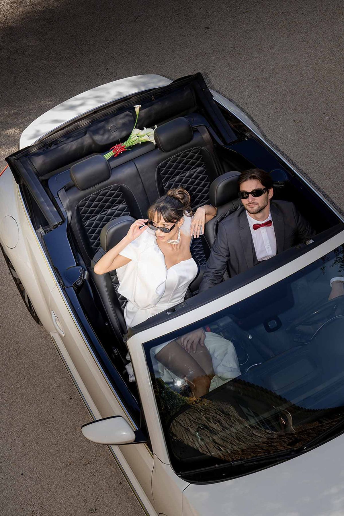 Aerial shot of couple riding vintage car at Château du Griffon
