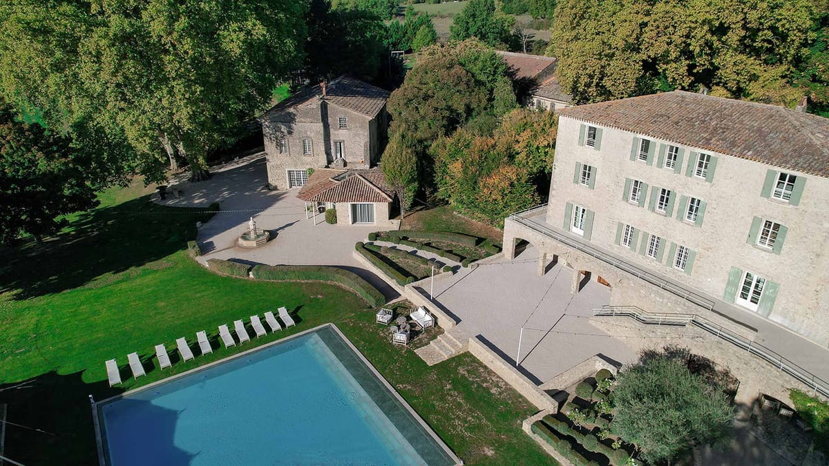 Wide aerial view of Château du Griffon estate with pool and grounds