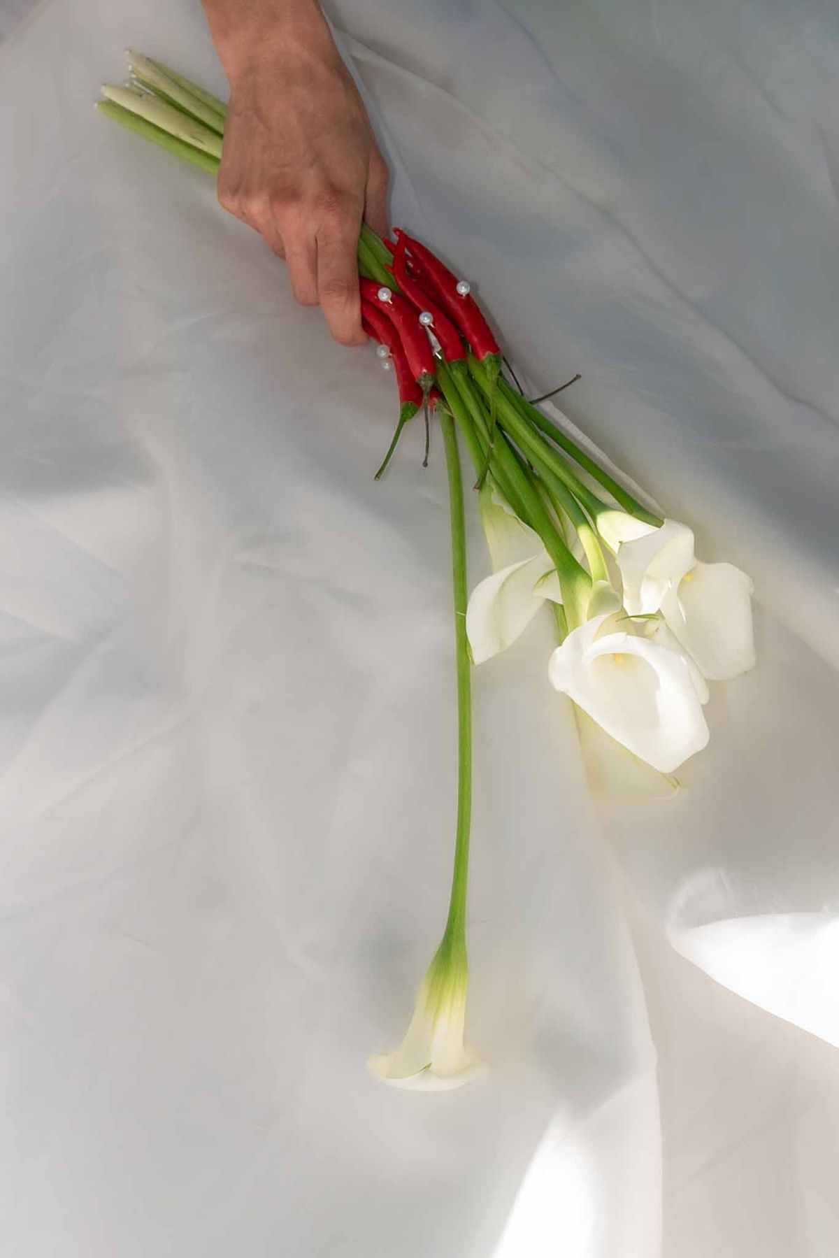 White tulip bouquet with red chilli stems and pearl decor