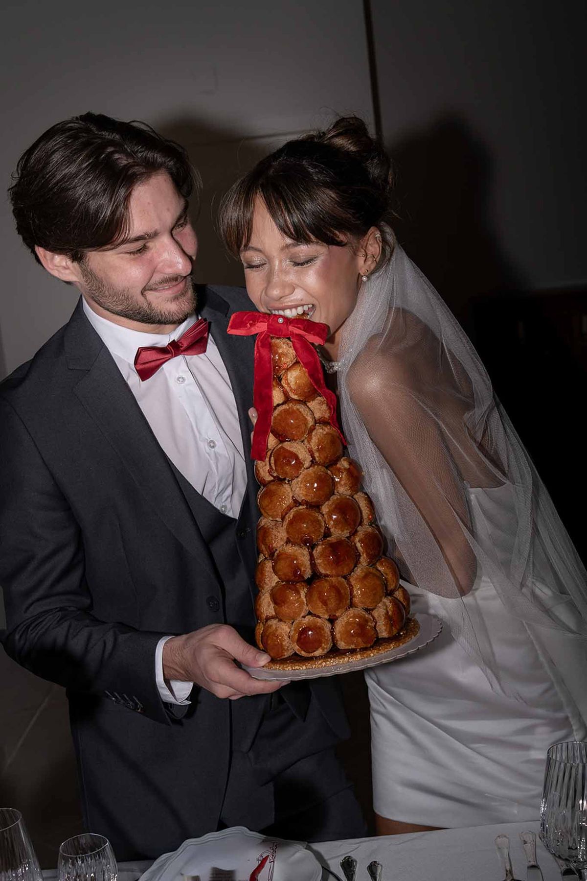 Bride and groom eating cake at reception