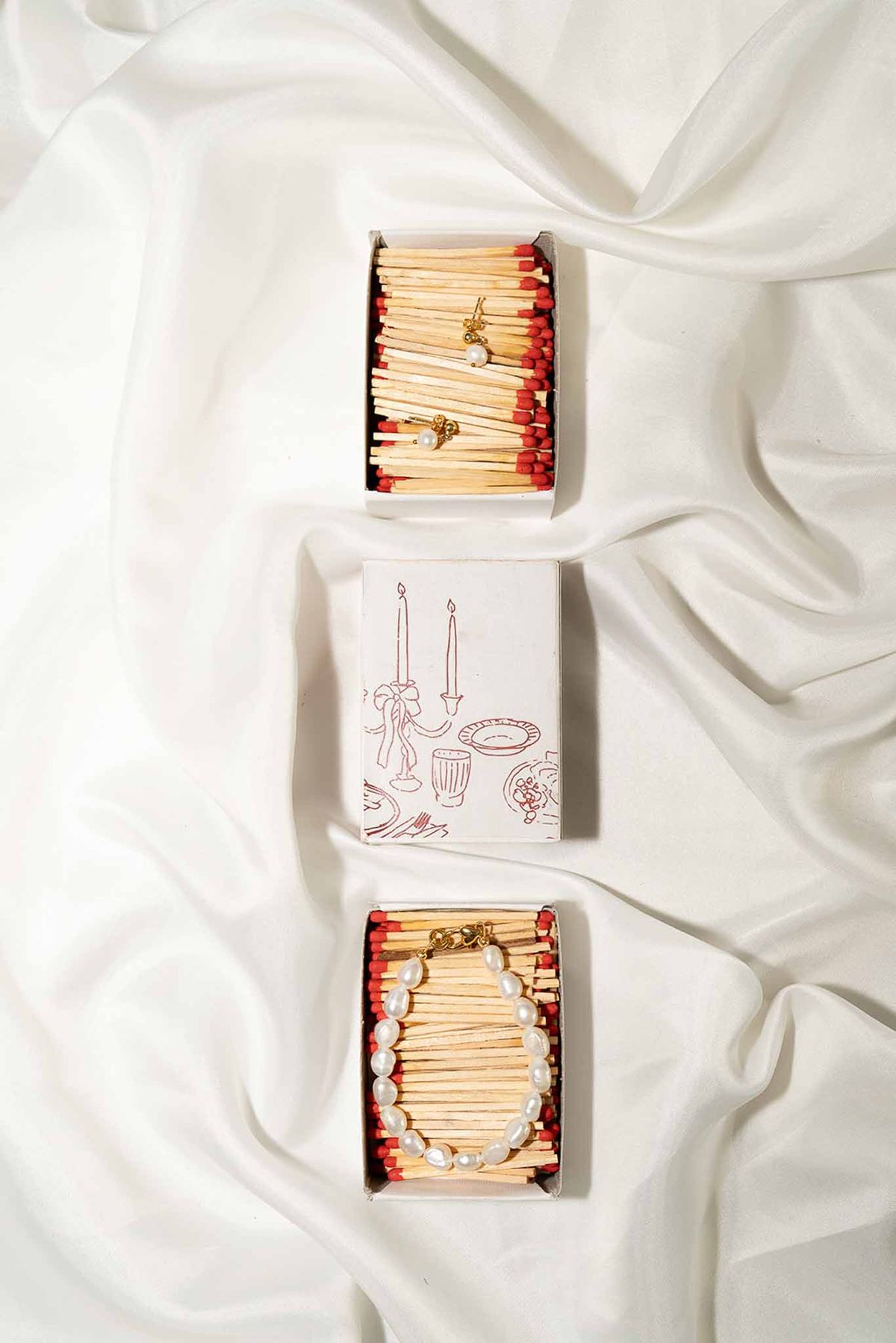 Flatlay with personalised matchsticks and pearls