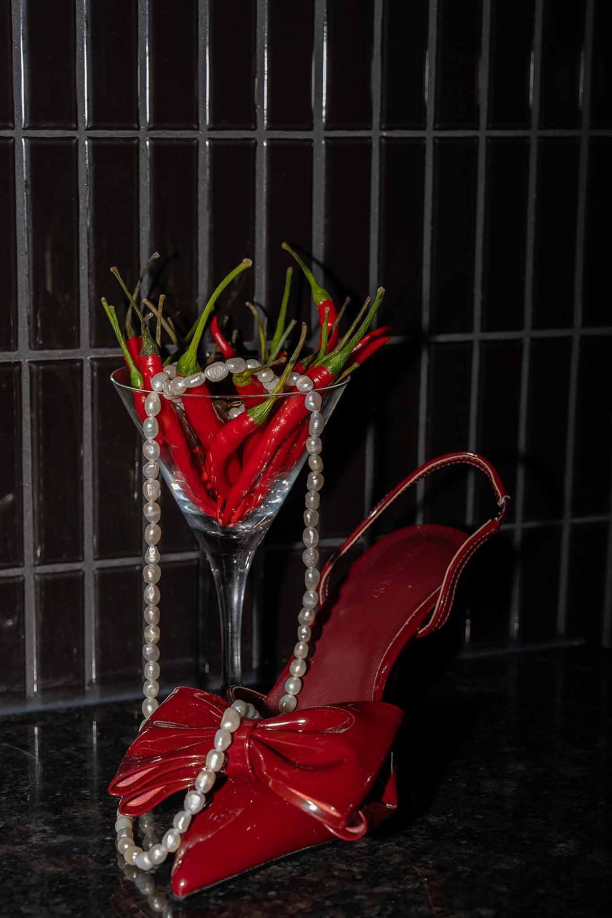 Red pointed shoes with chilli and champagne glass