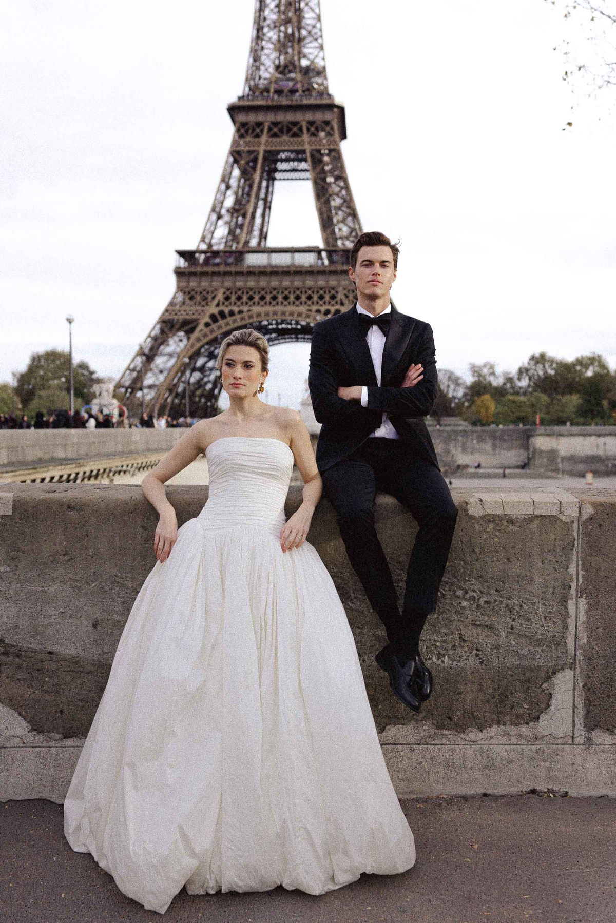 Bride and groom beneath the Eiffel Tower in a luxury Parisian wedding editorial