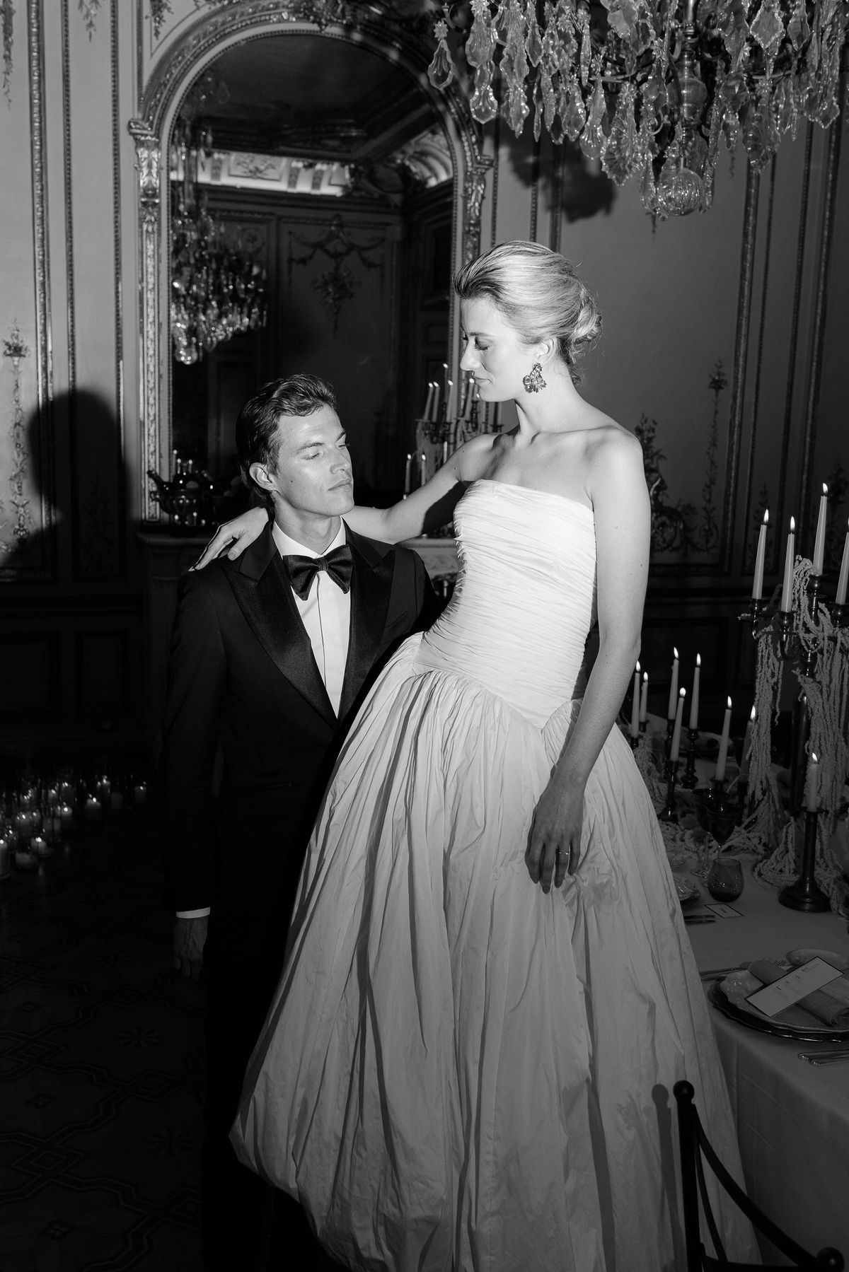Bride and groom in a candlelit salon, black and white