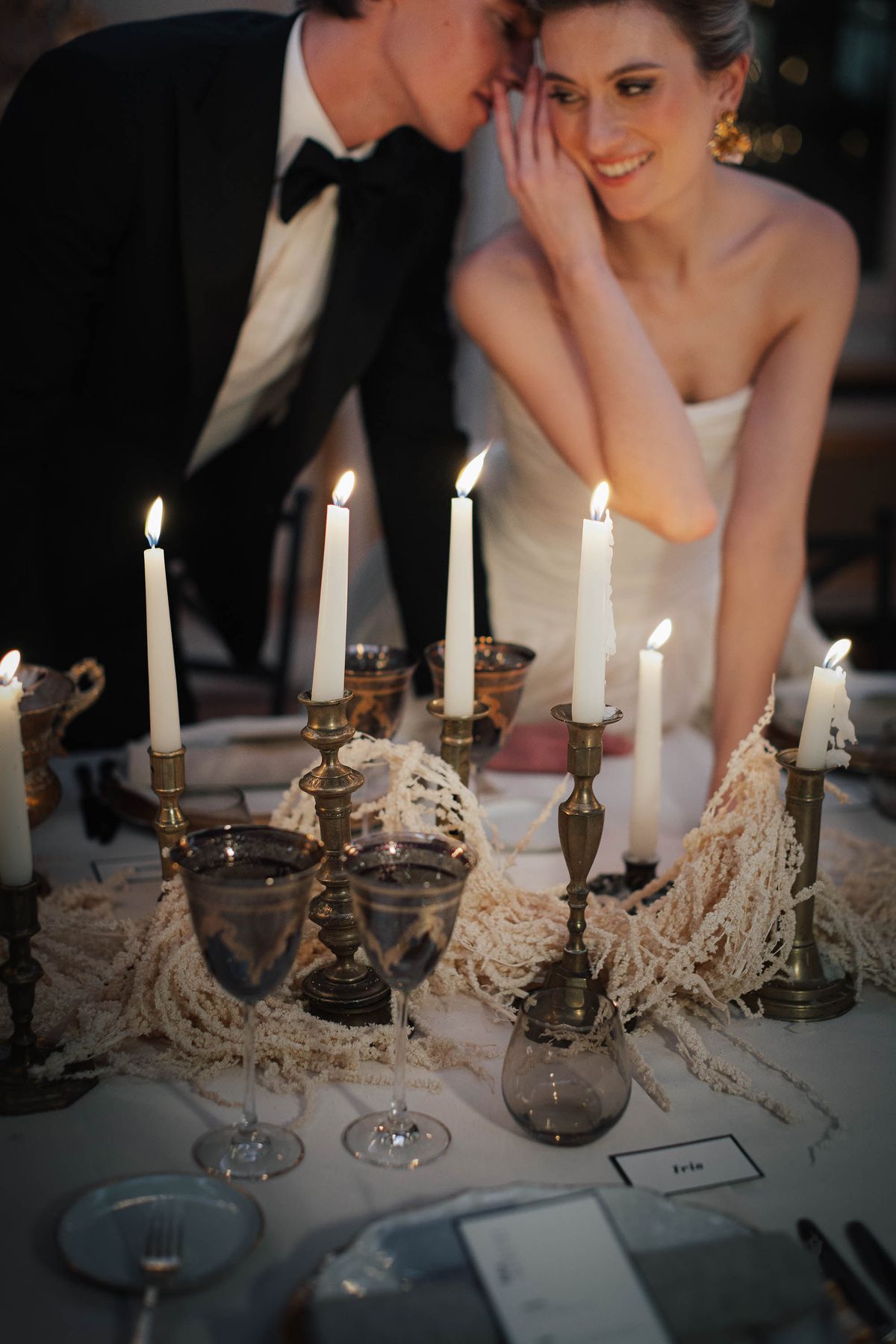 Taper candles and glassware along the dinner table