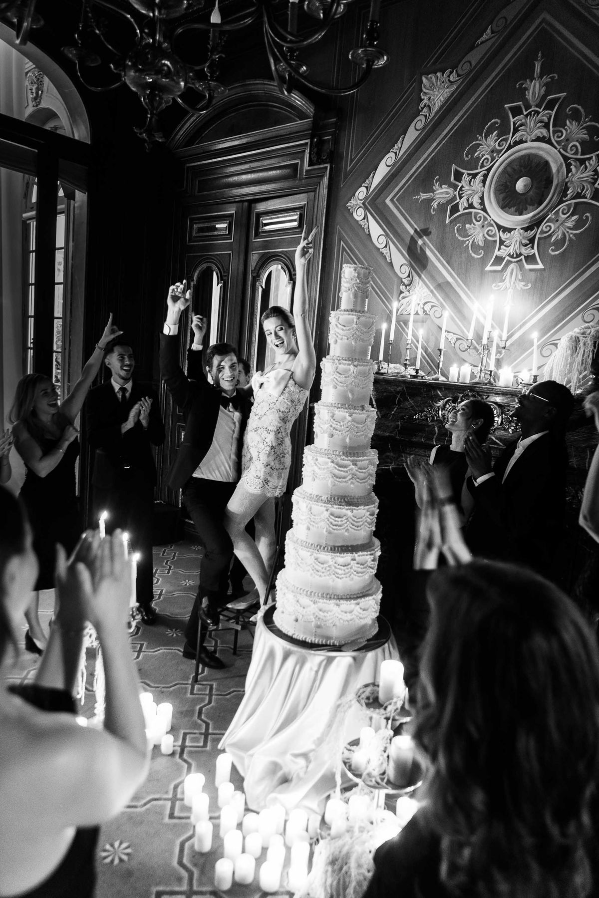 Guests dancing by candlelight in a black and white reception scene