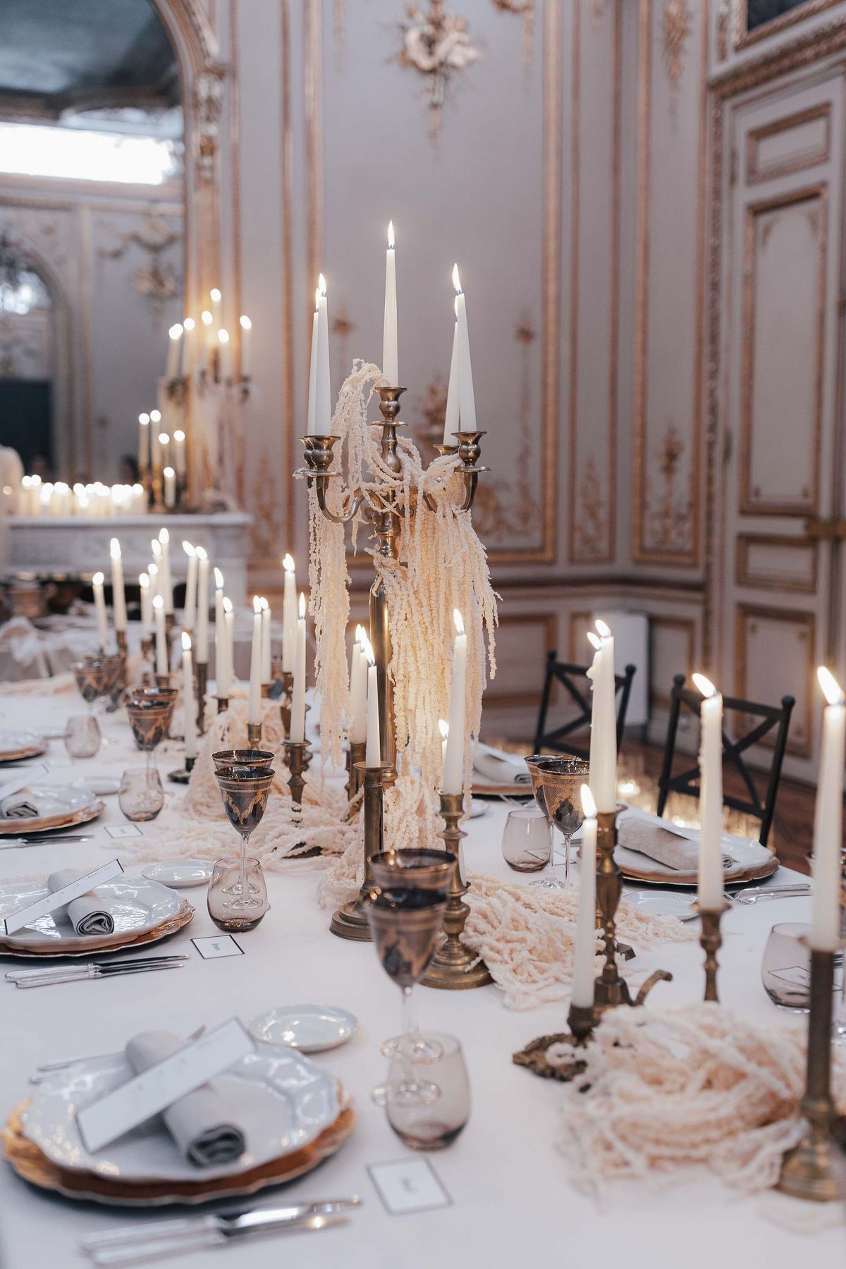 Tall candelabra and candlelight along the reception dinner table