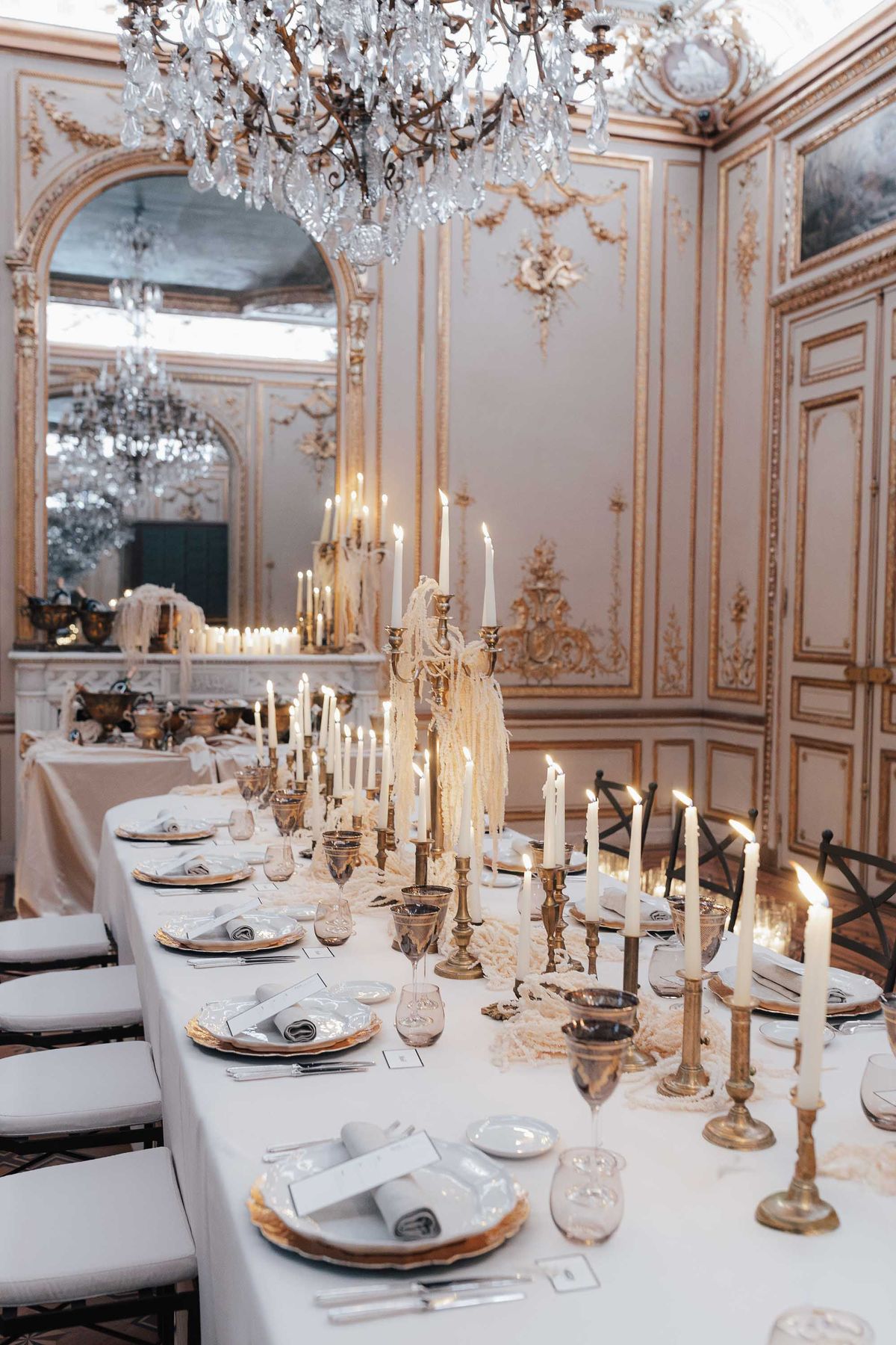 Candlelit dinner table in an ornate Parisian salon