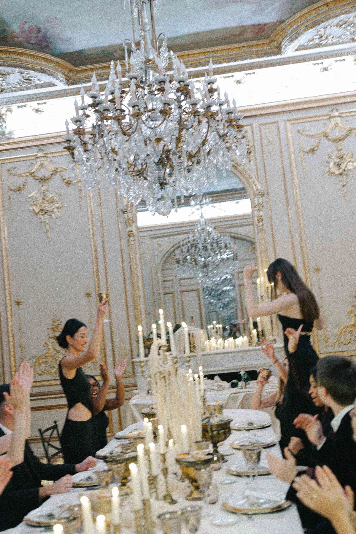 Guests dancing in a mirrored candlelit salon