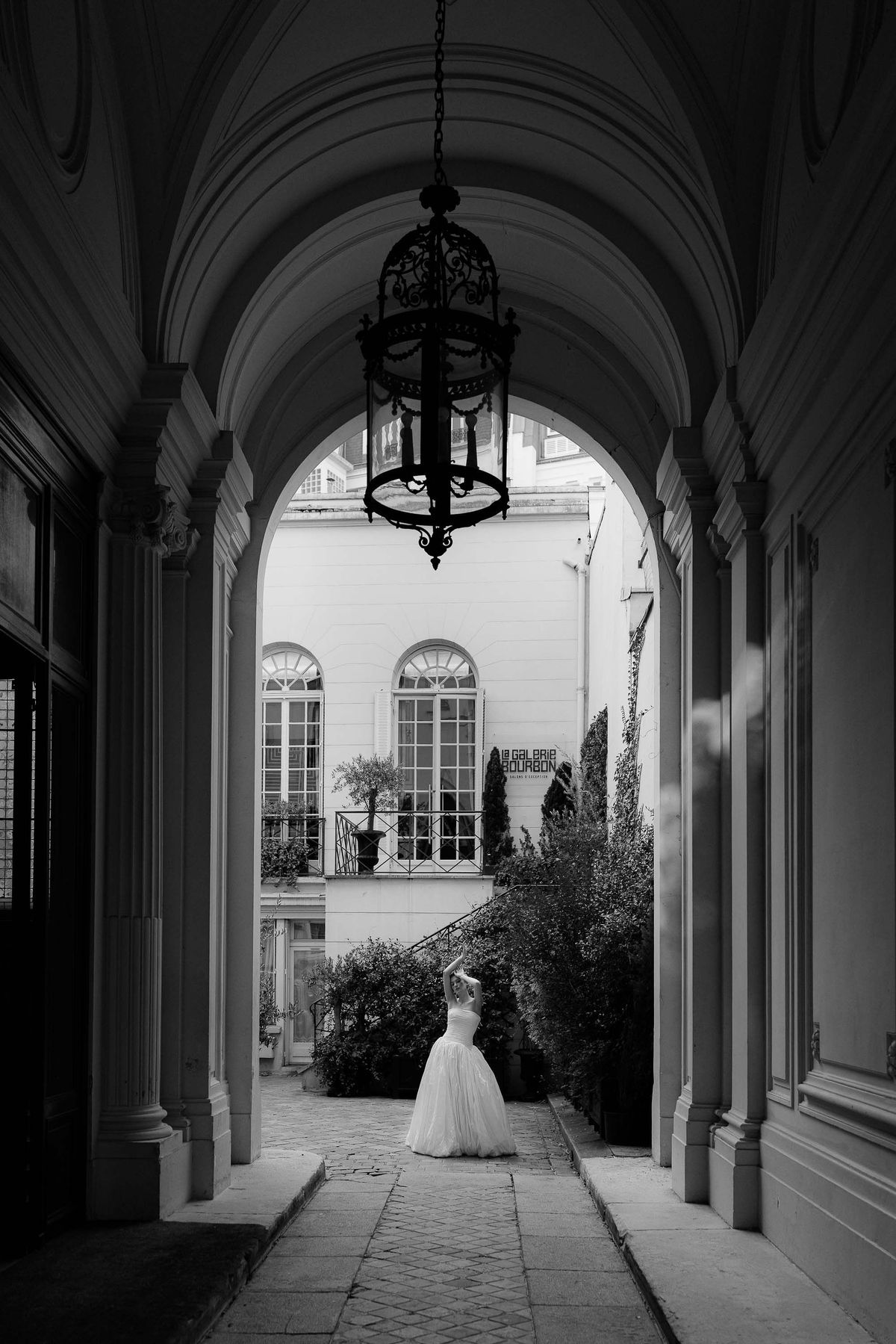 Arched windows and a lantern in a hallway at La Galerie Bourbon, Paris