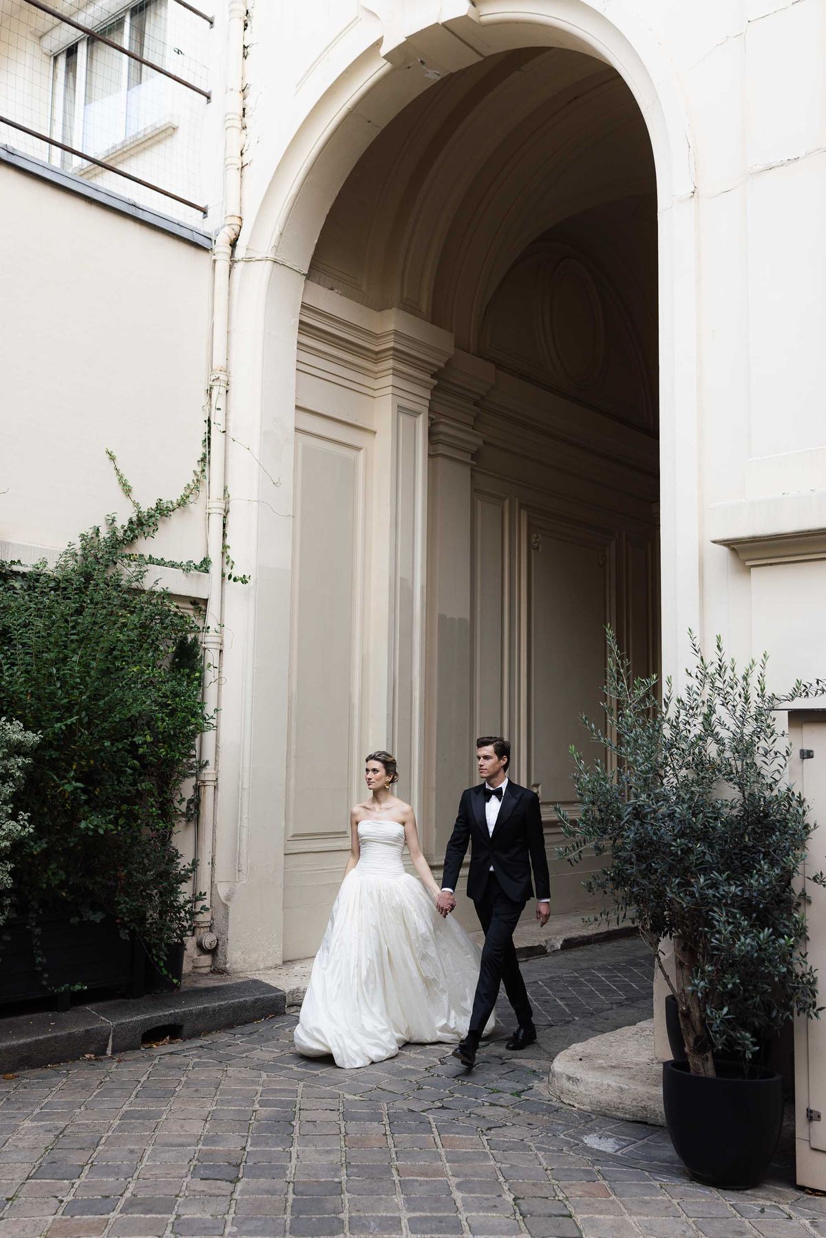 Couple outside the facade of La Galerie Bourbon in Paris