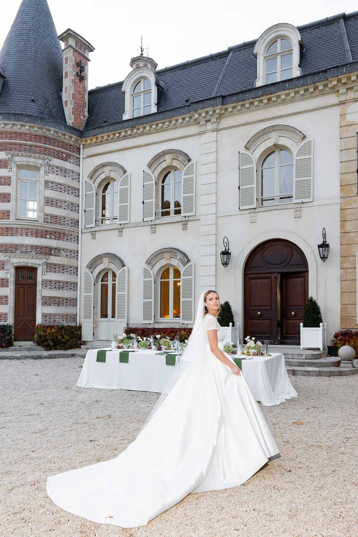 Bride in ball gown before the Napoleon III façade of Château Comtesse Lafond