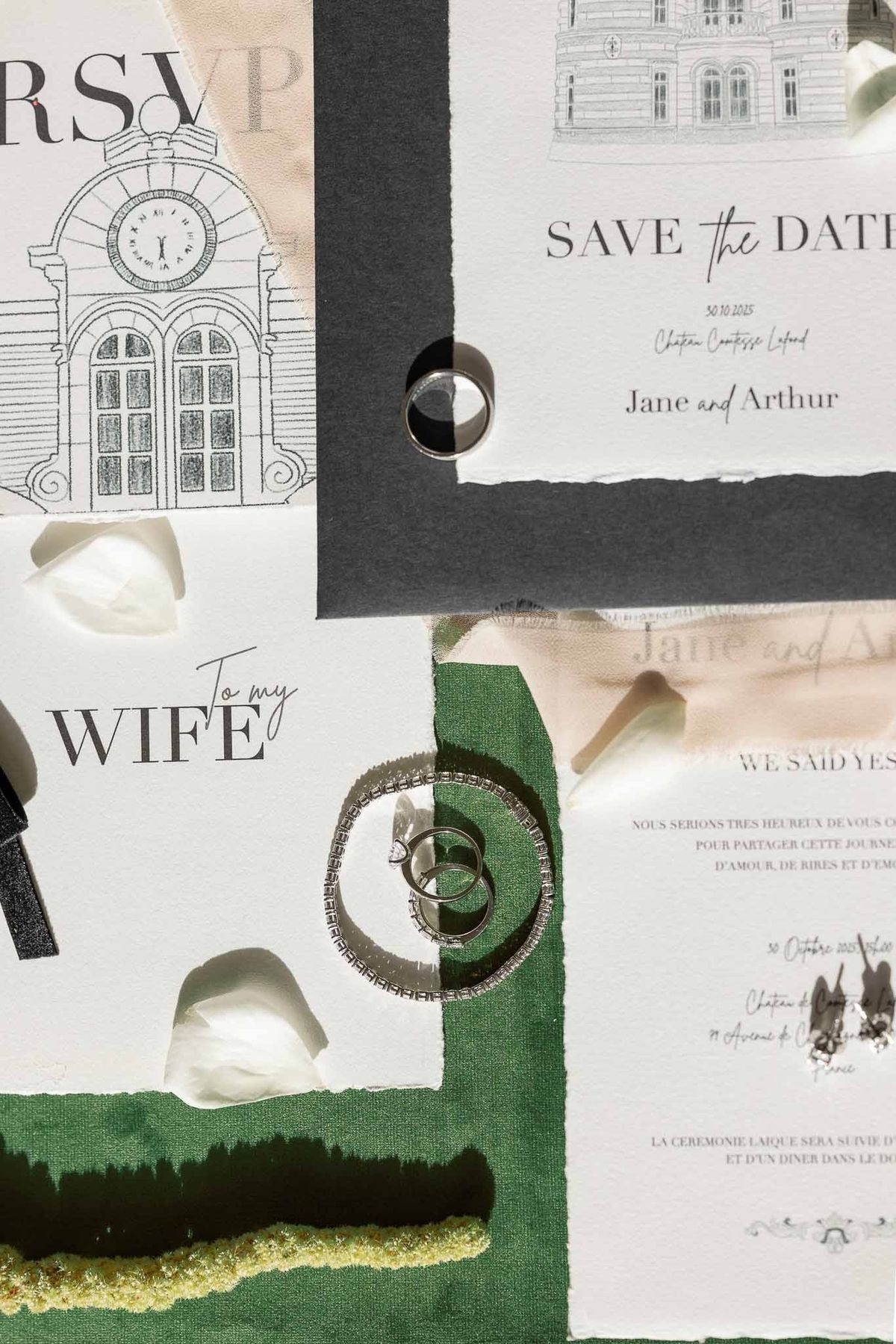 Wedding stationery suite with château illustrations and rings on green velvet at Château Comtesse Lafond
