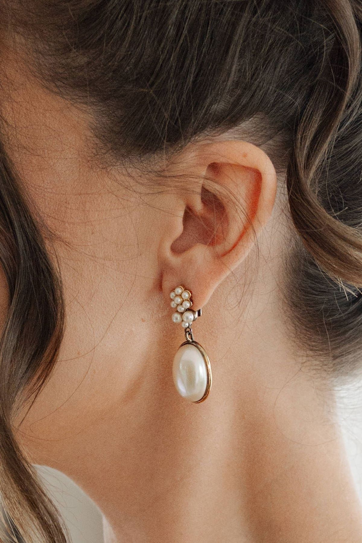 Close-up of bride's vintage pearl drop earring with seed pearl cluster