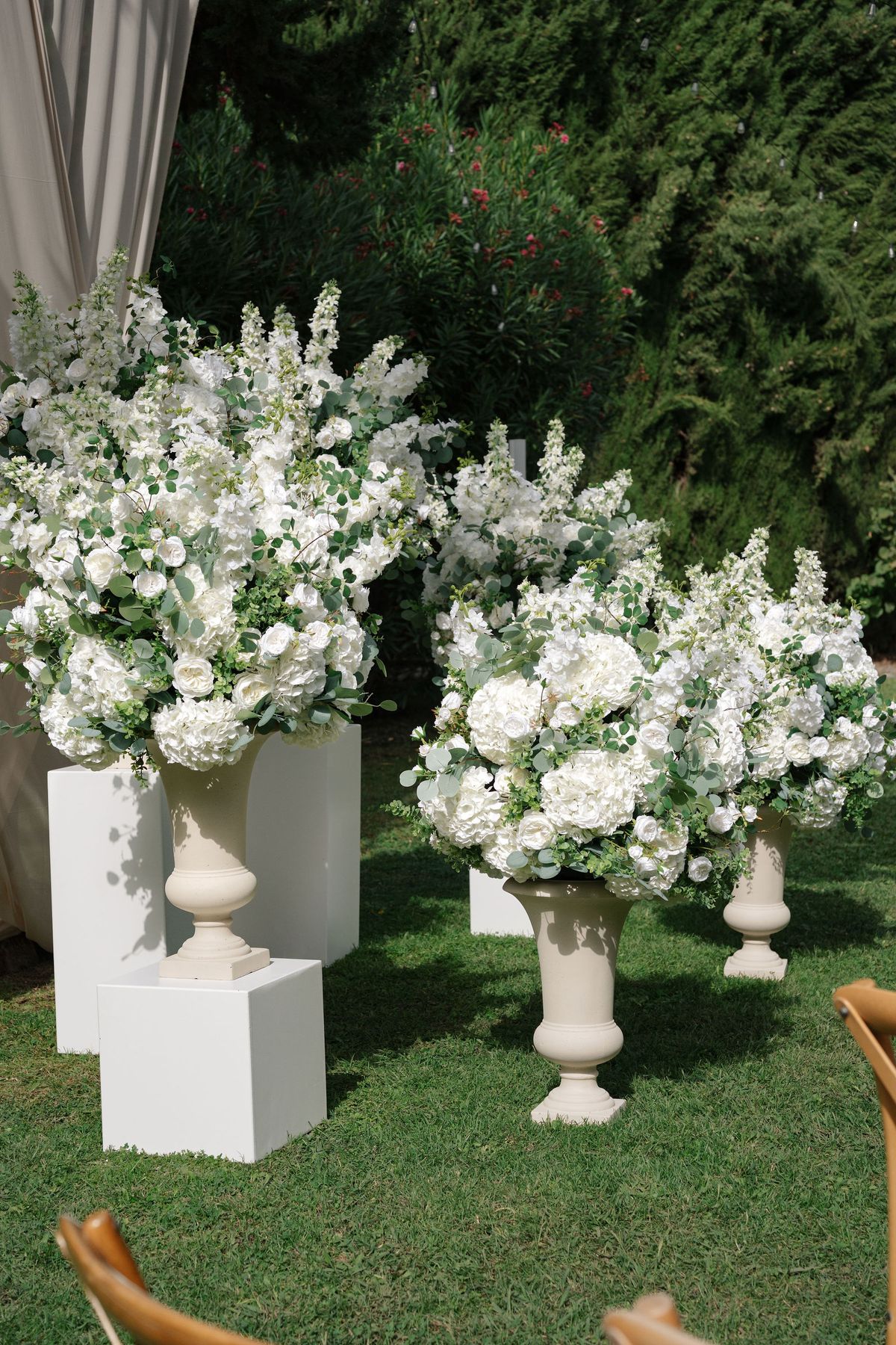 Detail of white hydrangea and rose floral urns at outdoor ceremony