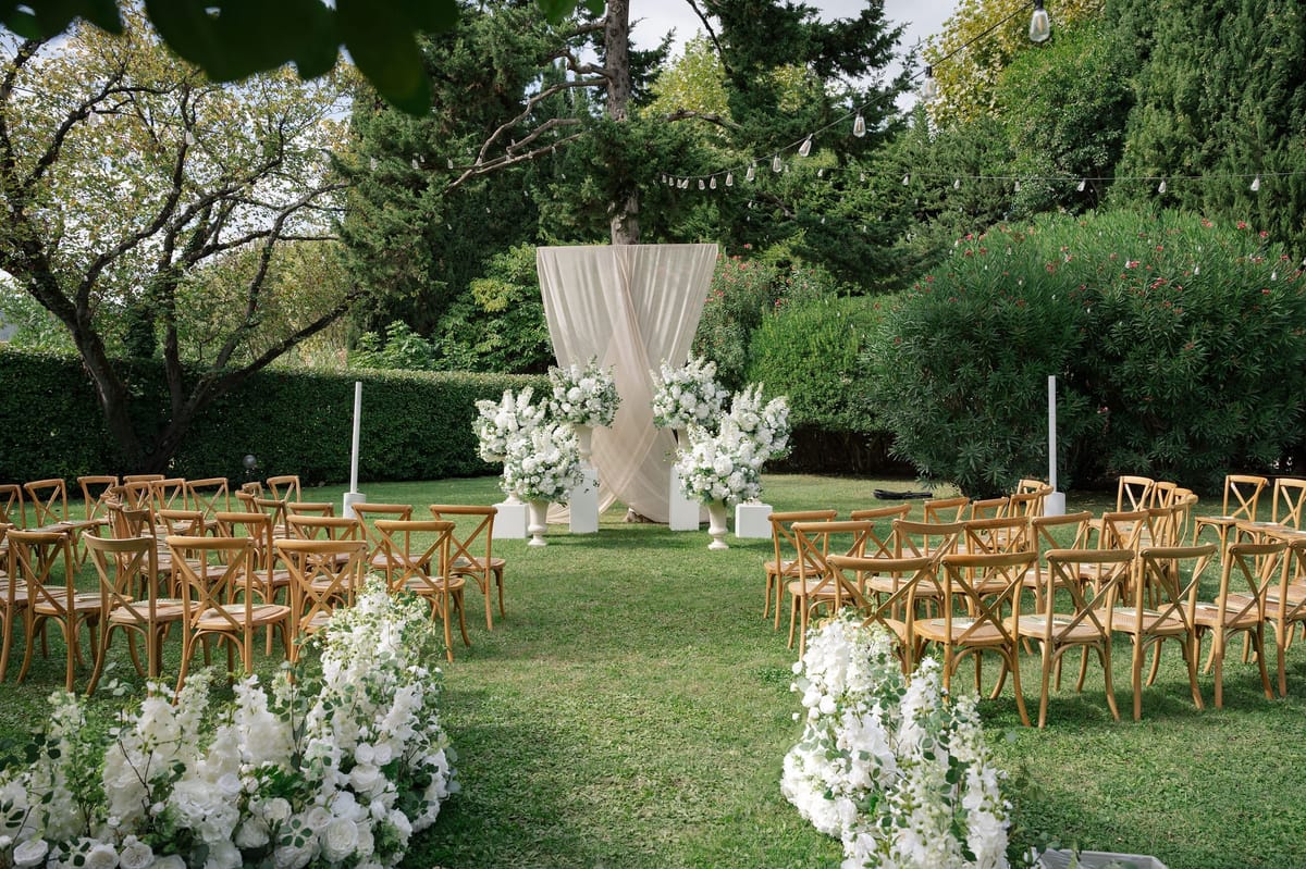 Aisle view of empty ceremony with floral meadow leading to altar