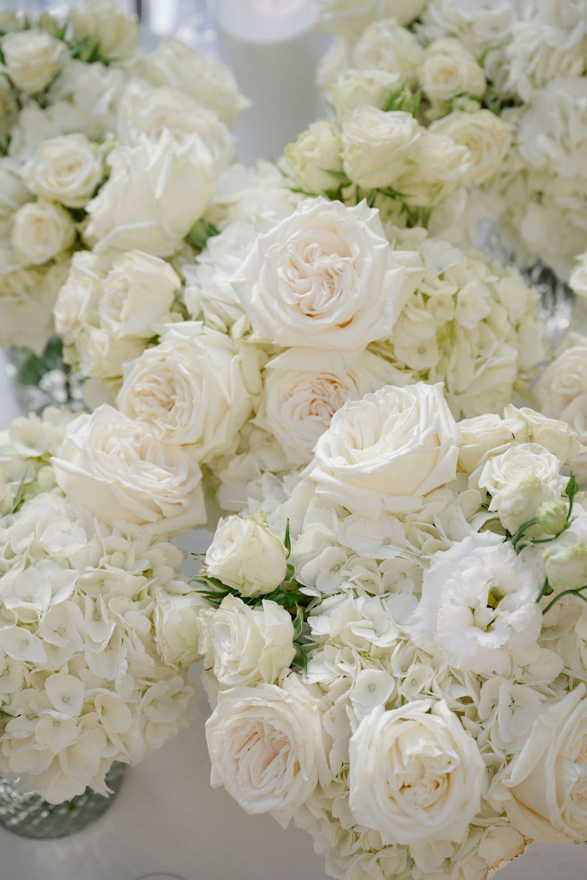 Close-up of white garden rose and hydrangea wedding floral arrangements