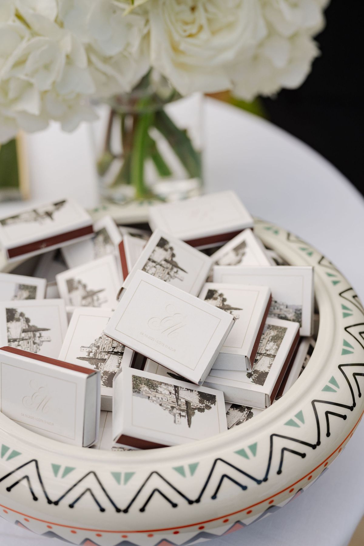 Vintage ceramic bowl filled with monogrammed wedding matchbook favours