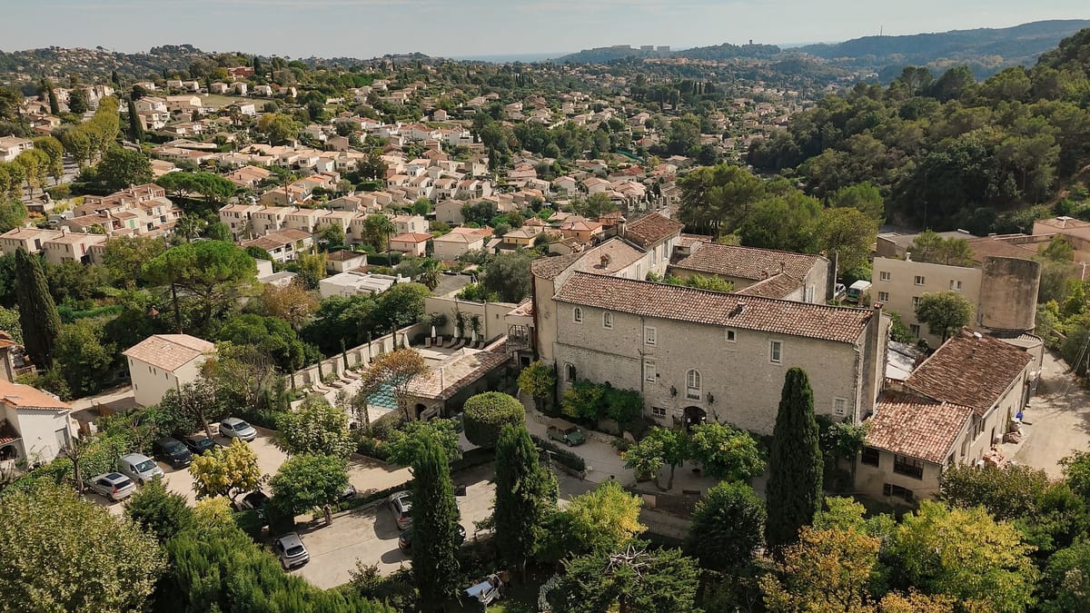 Aerial view of chateau set within hillside Cote d'Azur village