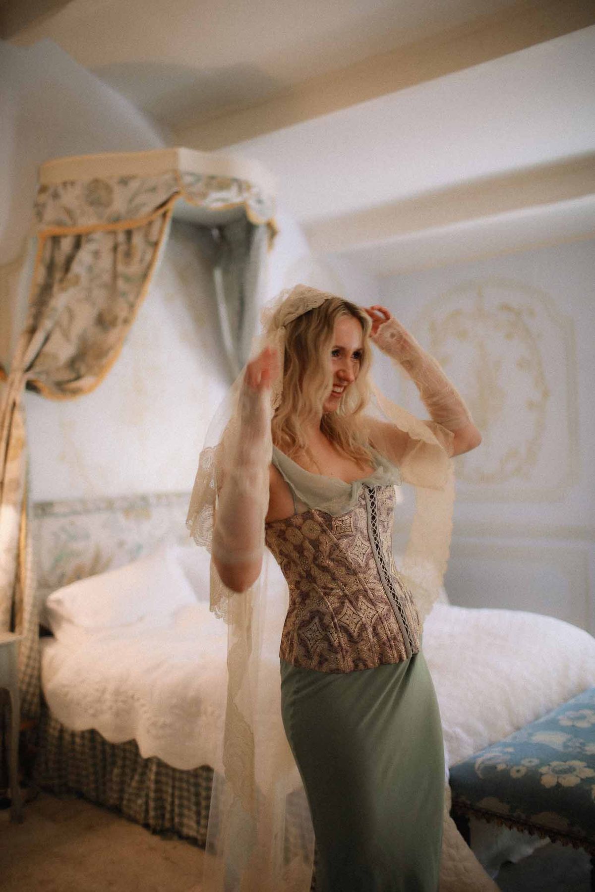 Bride having her lace veil placed before the ceremony at Chateau St Victor Lacoste
