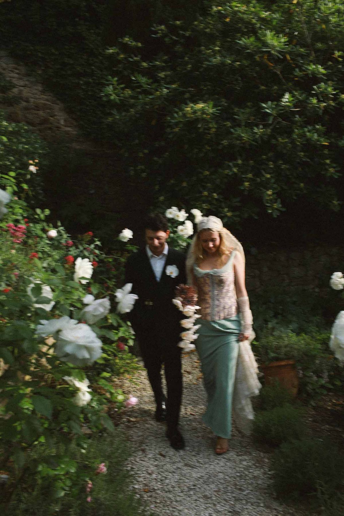 Couple walking through garden at sunset at Chateau St Victor Lacoste