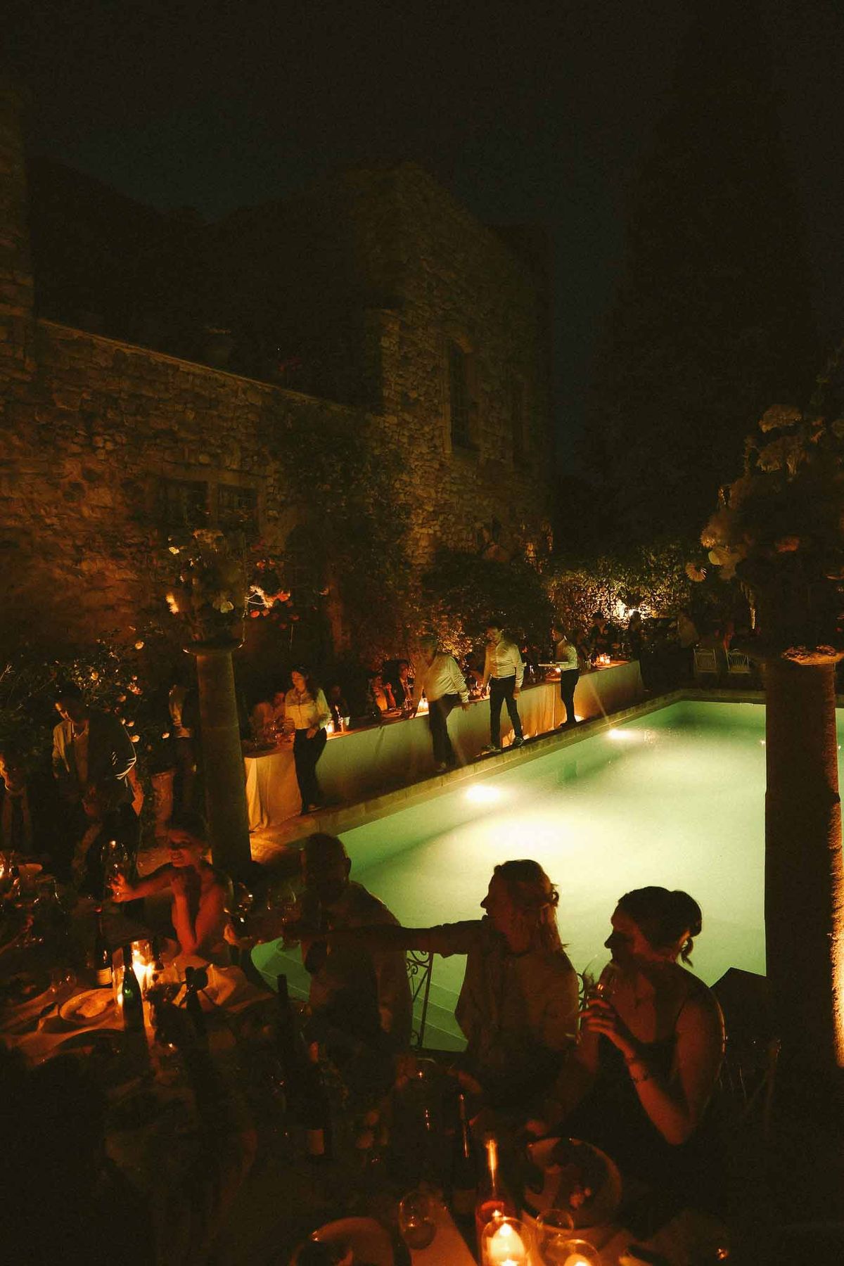 Evening dinner scene beside the pool at Chateau St Victor Lacoste