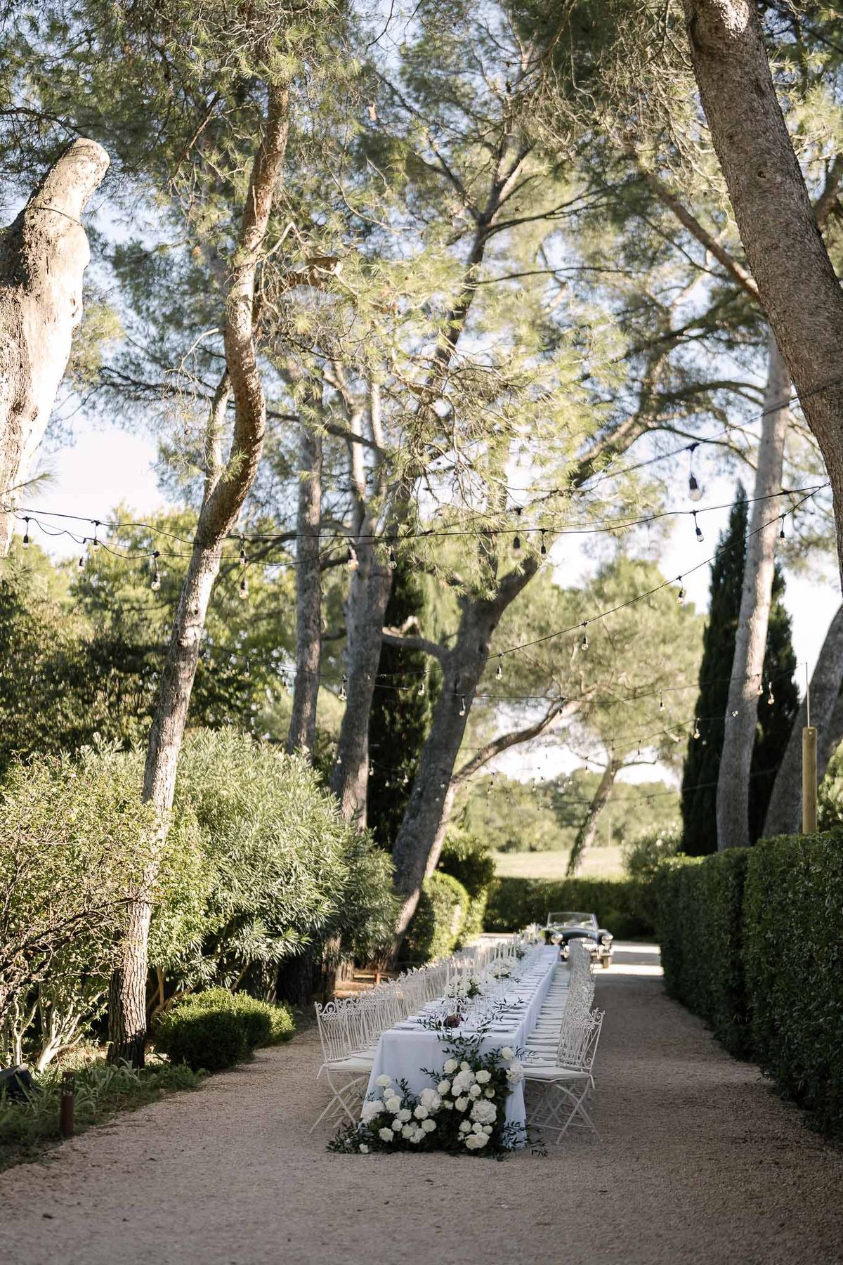 Wedding reception table setting in a garden with peonies