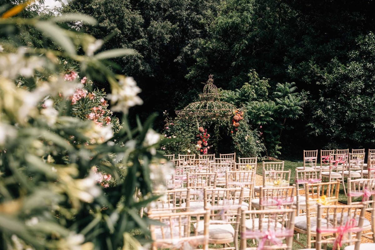 Wedding ceremony setup in a garden with white roses