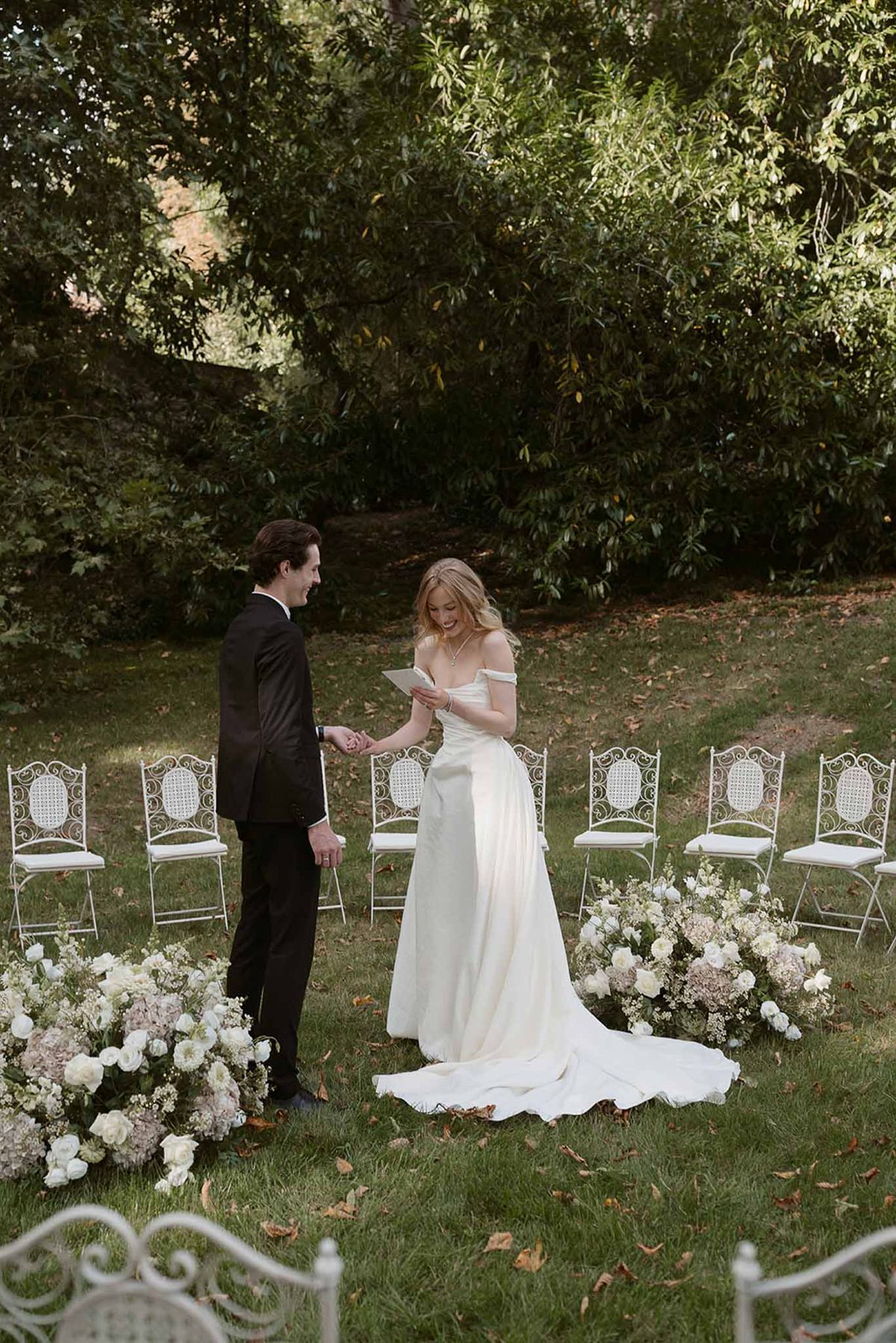 Wedding ceremony setup in a garden with white roses