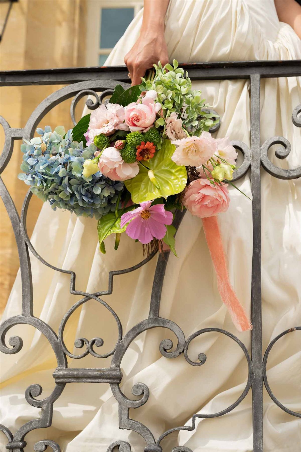 Colourful bridal bouquet on wrought-iron balcony at Chateau de Villette
