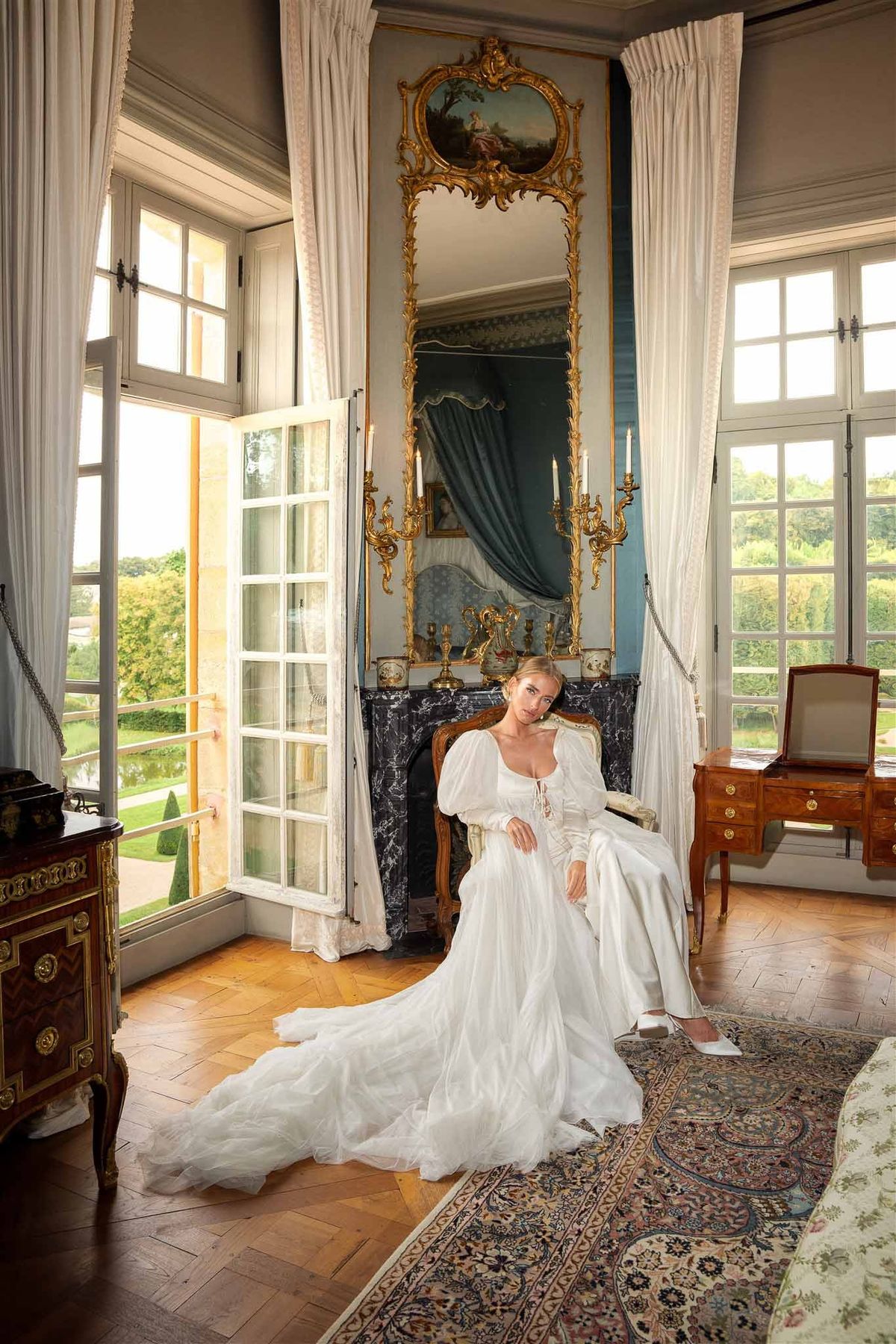 Bride in gilded salon with marble fireplace at Chateau de Villette