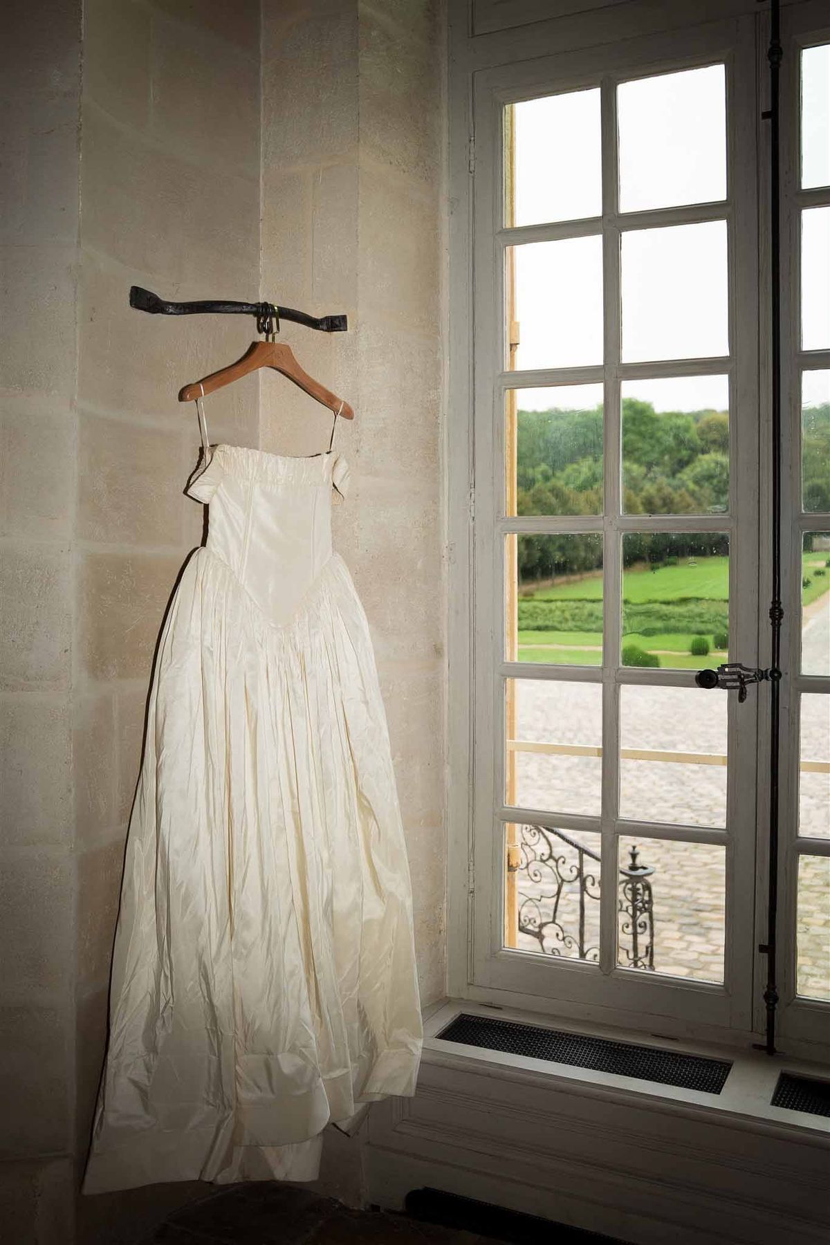 Ball gown hanging by window at Chateau de Villette