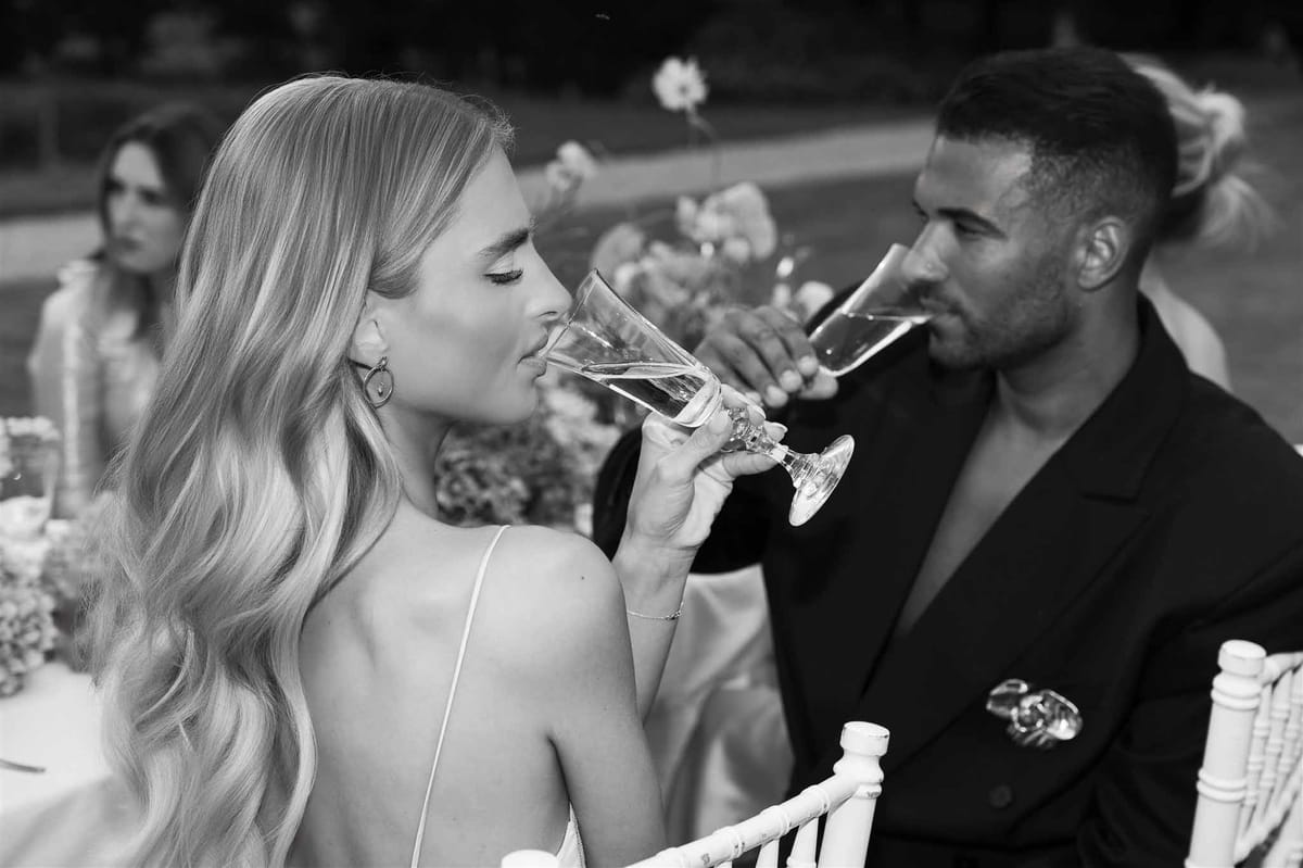 Couple drinking champagne at reception at Chateau de Villette