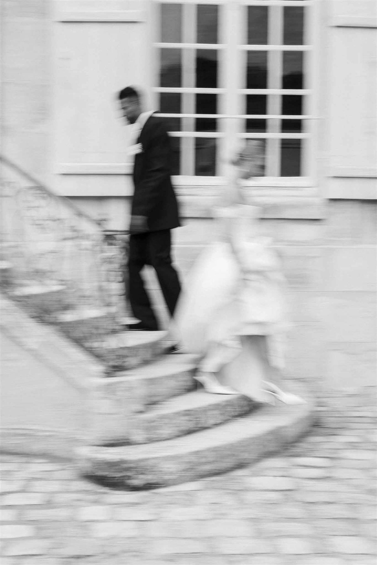 Motion blur of couple on stairs at Chateau de Villette