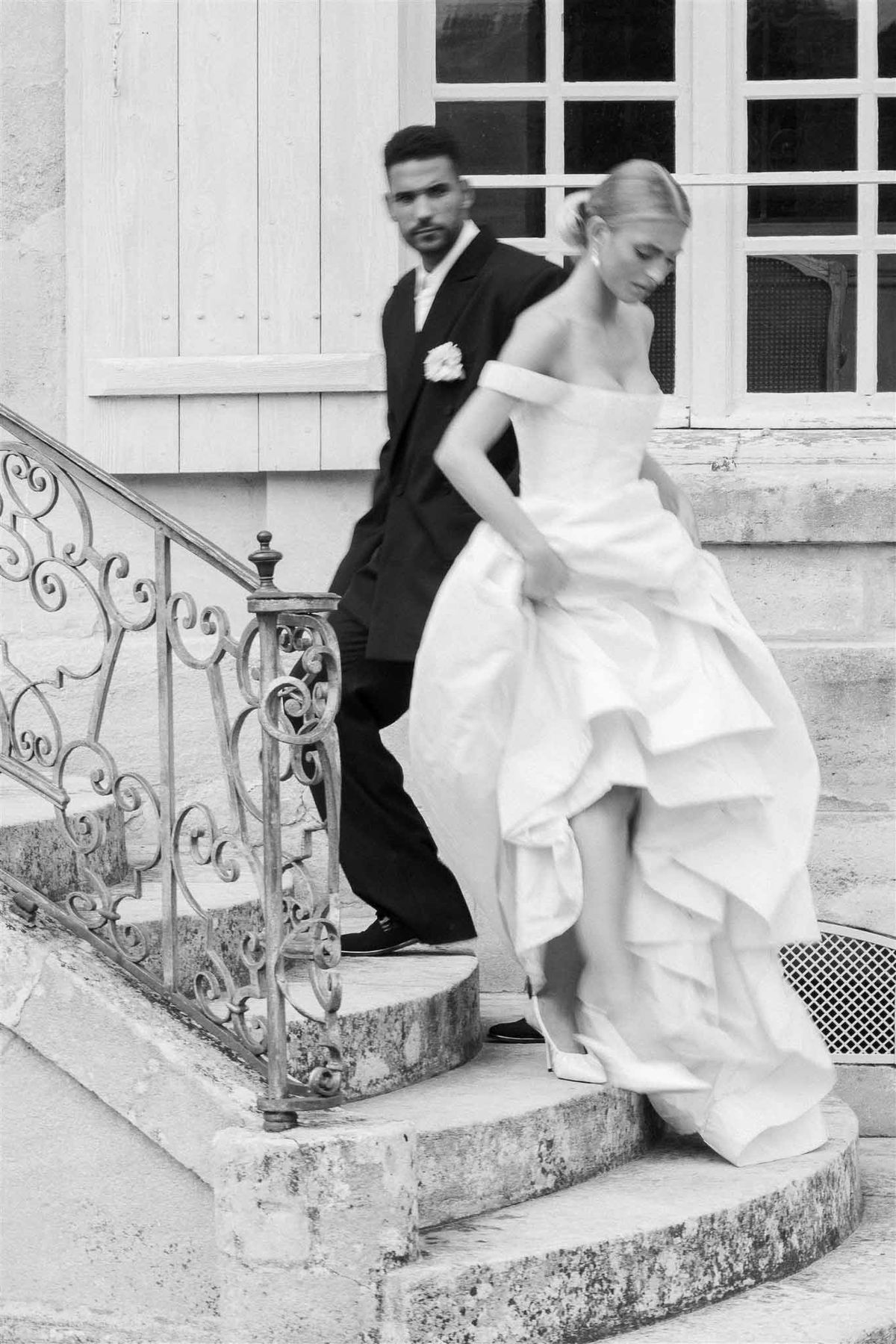 Couple descending staircase at Chateau de Villette