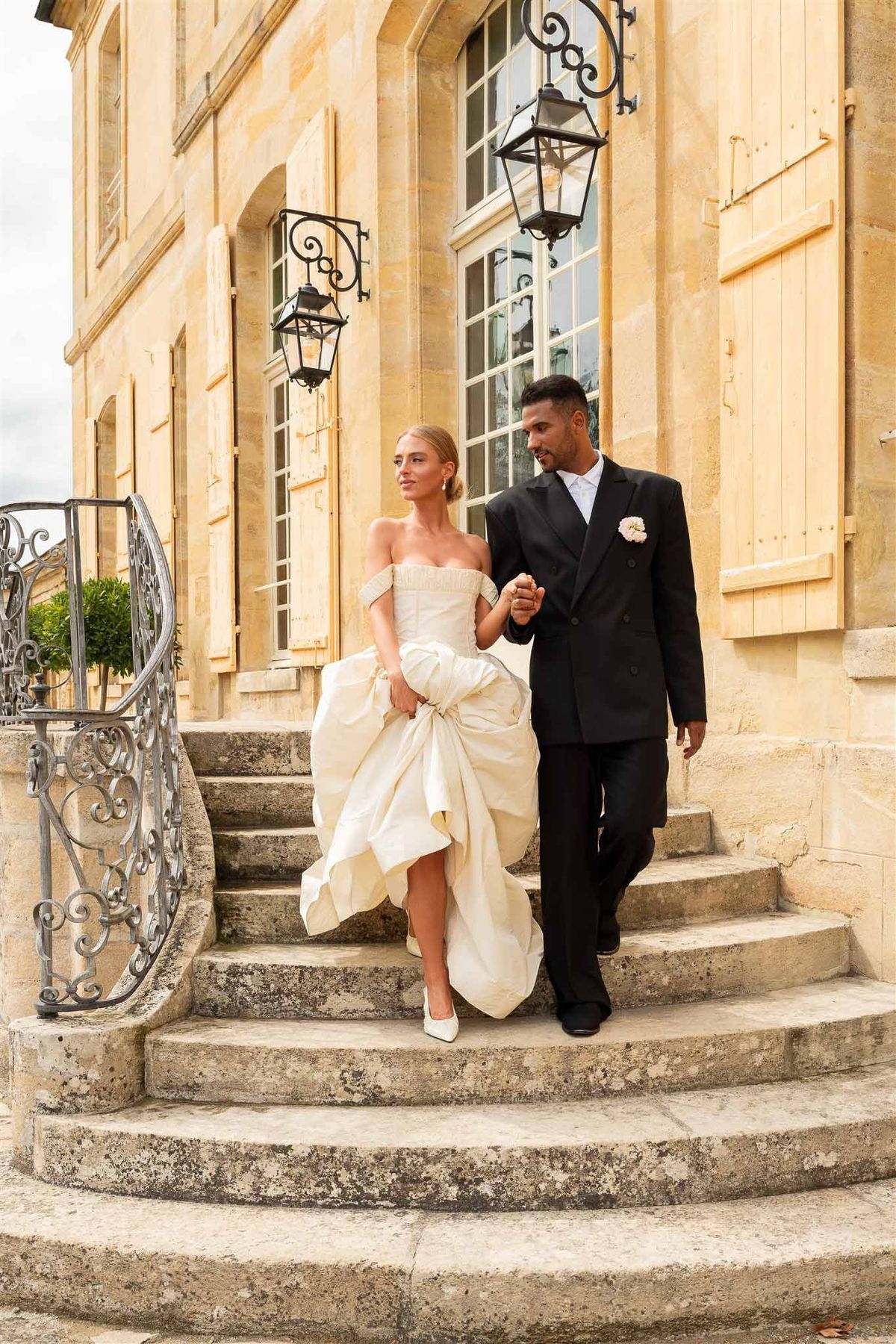 Couple walking down steps at Chateau de Villette
