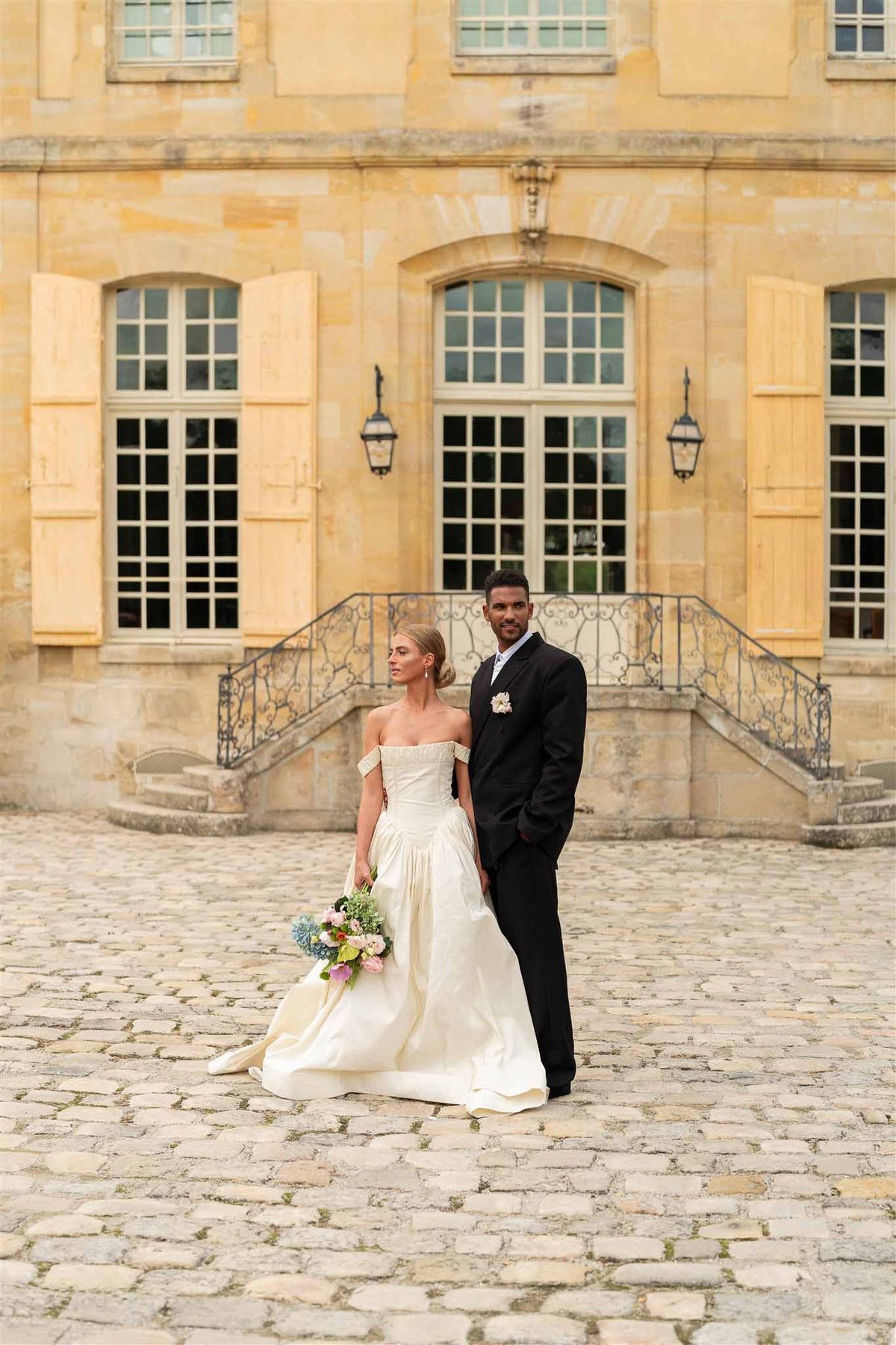 Couple portrait in courtyard at Chateau de Villette