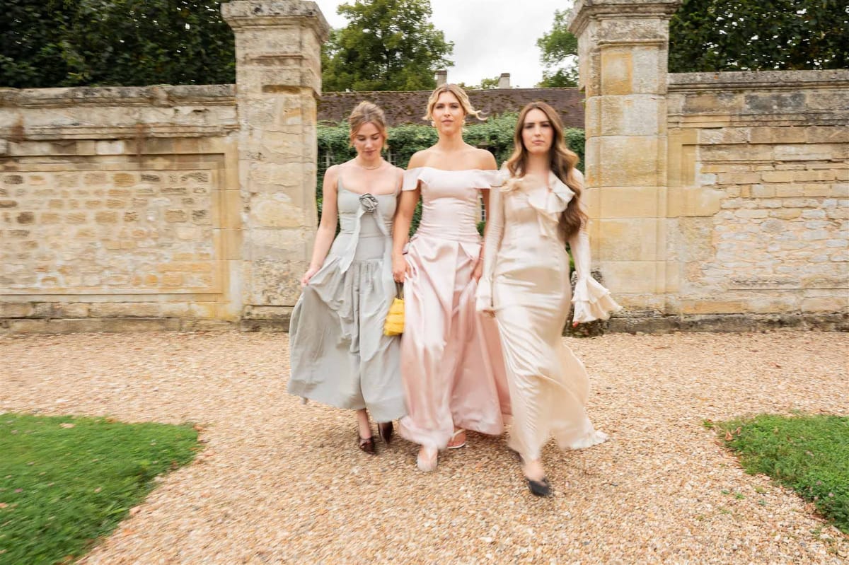 Bridesmaids in pastel gowns walking at Chateau de Villette