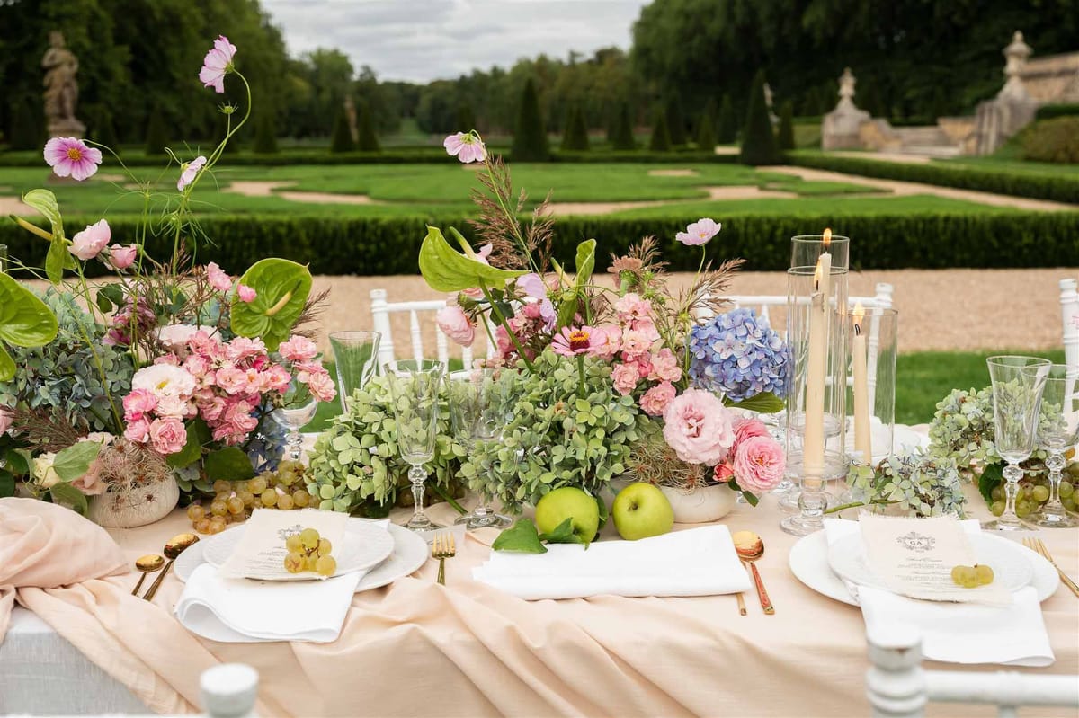 Garden reception table overlooking parterre at Chateau de Villette
