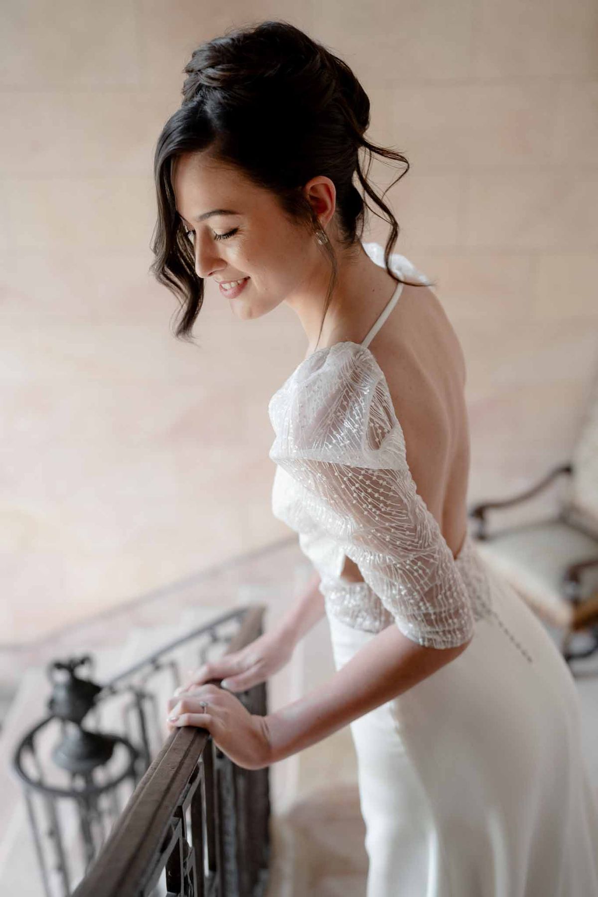 Bride wearing sparkly open-back wedding dress at Chateau d'Arcelot