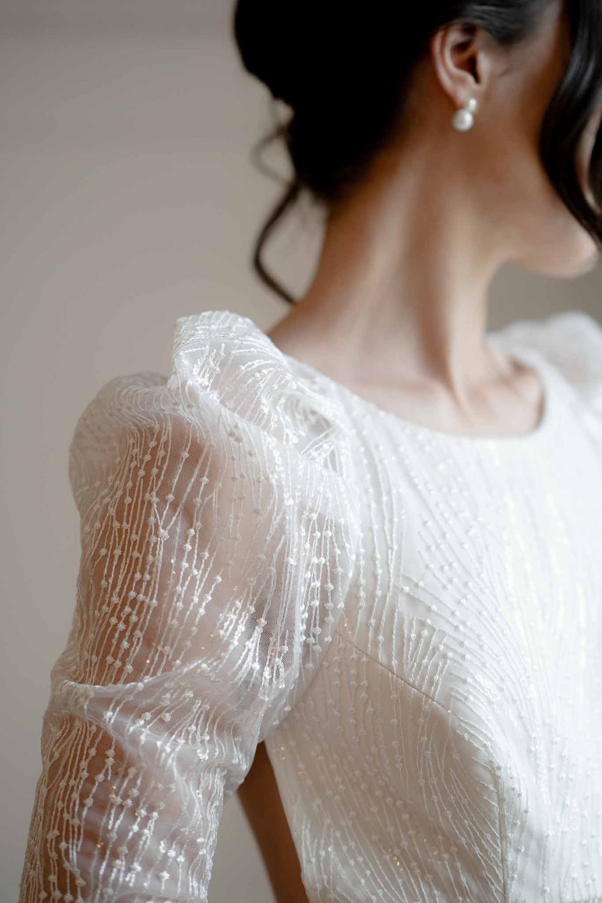 Bride in sparkly wedding dress with statement puff sleeves