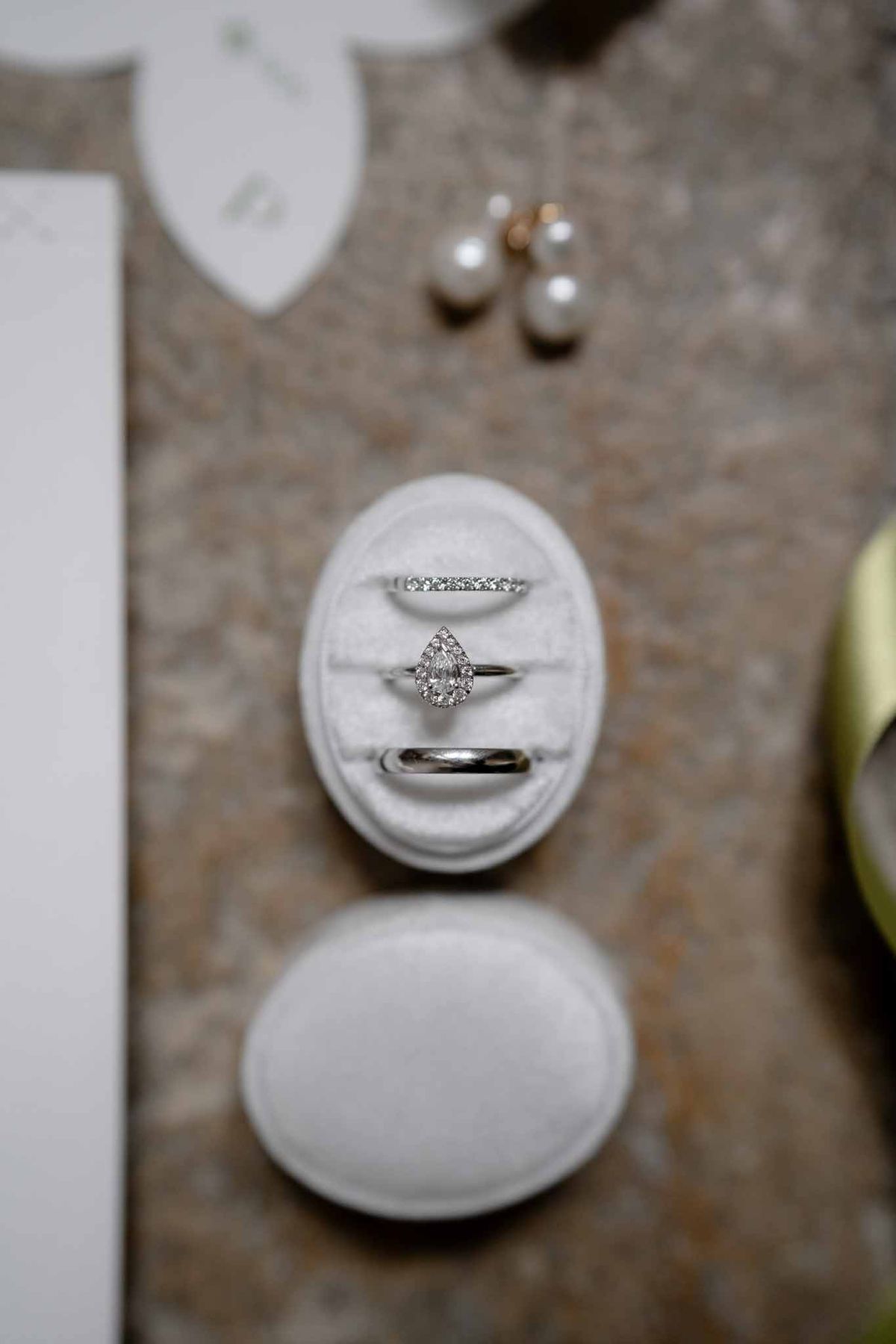 Flatlay arrangement of bridal accessories including rings, earrings, and jewellery box