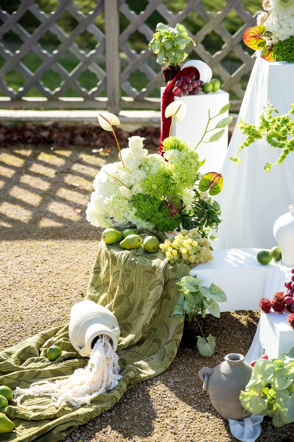 Ceremony backdrop close up with terracotta amphora, hanging amaranthus and hydrangea clusters