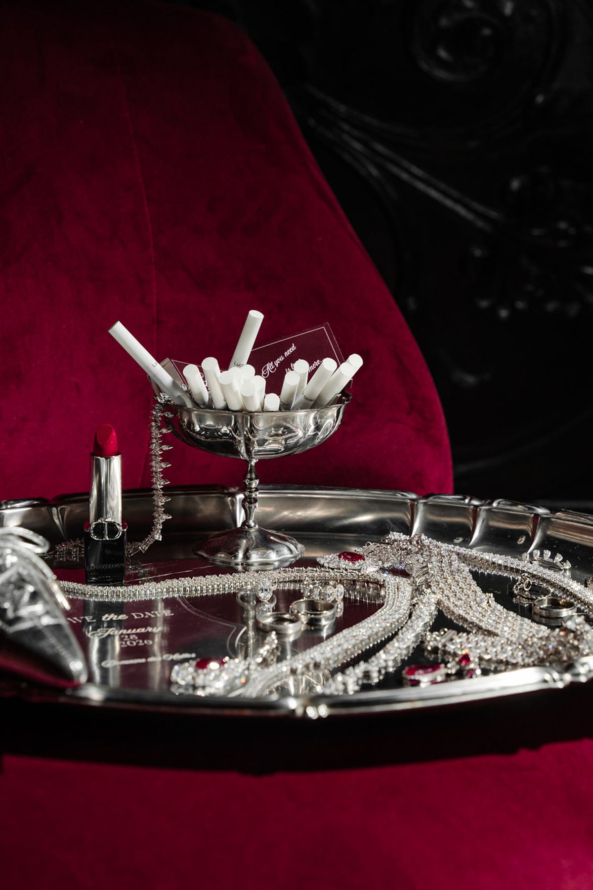 Bridal accessories still life with jewellery and lipstick on red velvet at Domaine des Halles