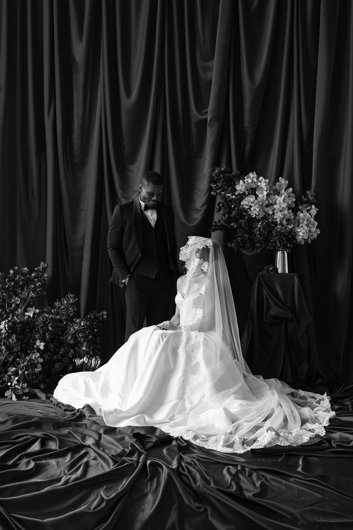 Black and white formal couple portrait with satin backdrop at Domaine des Halles