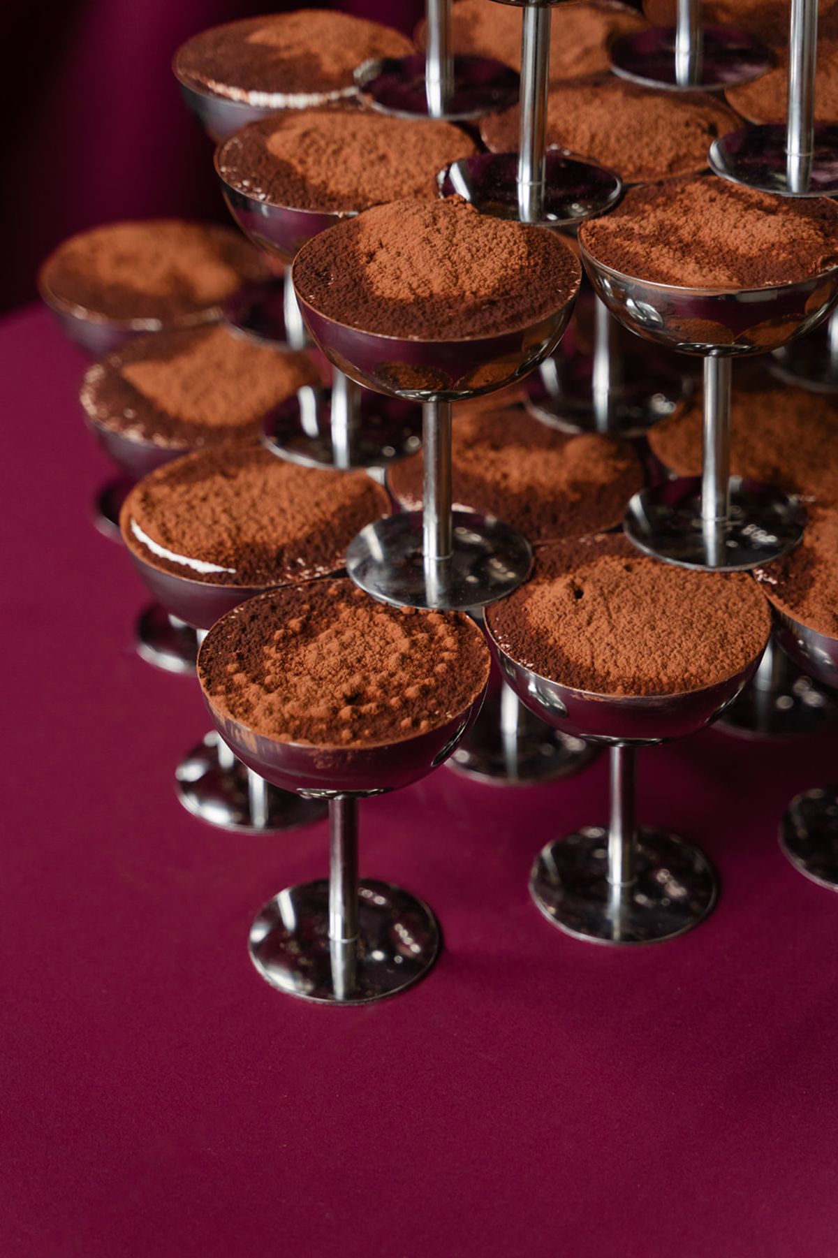 Tiramisu tower in silver coupes on burgundy linen at Domaine des Halles wedding