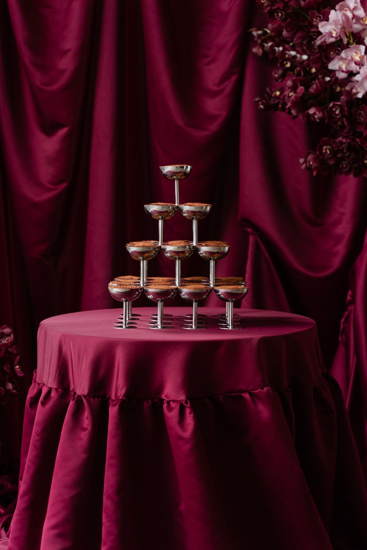 Tiramisu coupe tower on satin table with orchids at Domaine des Halles
