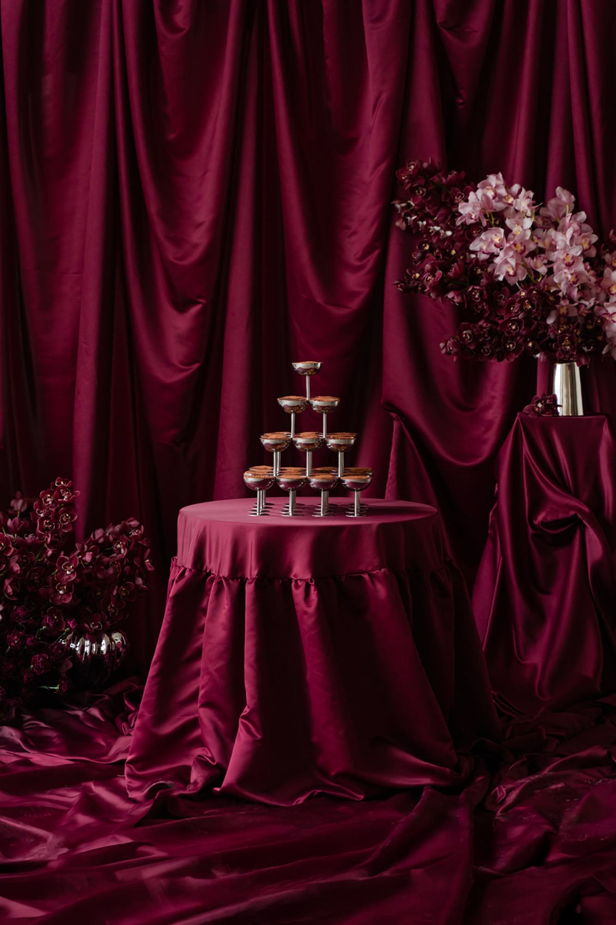 Tiramisu tower with magenta satin backdrop and orchid pedestals at Domaine des Halles