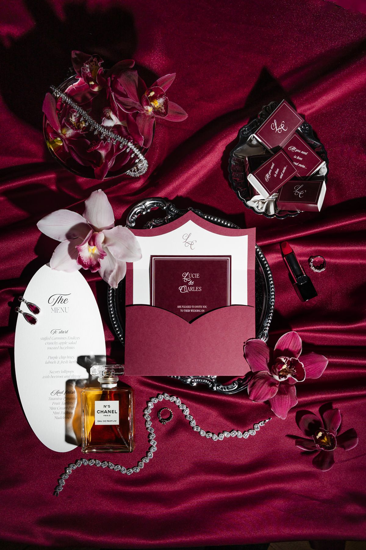 Full stationery suite flatlay with bridal accessories at Domaine des Halles