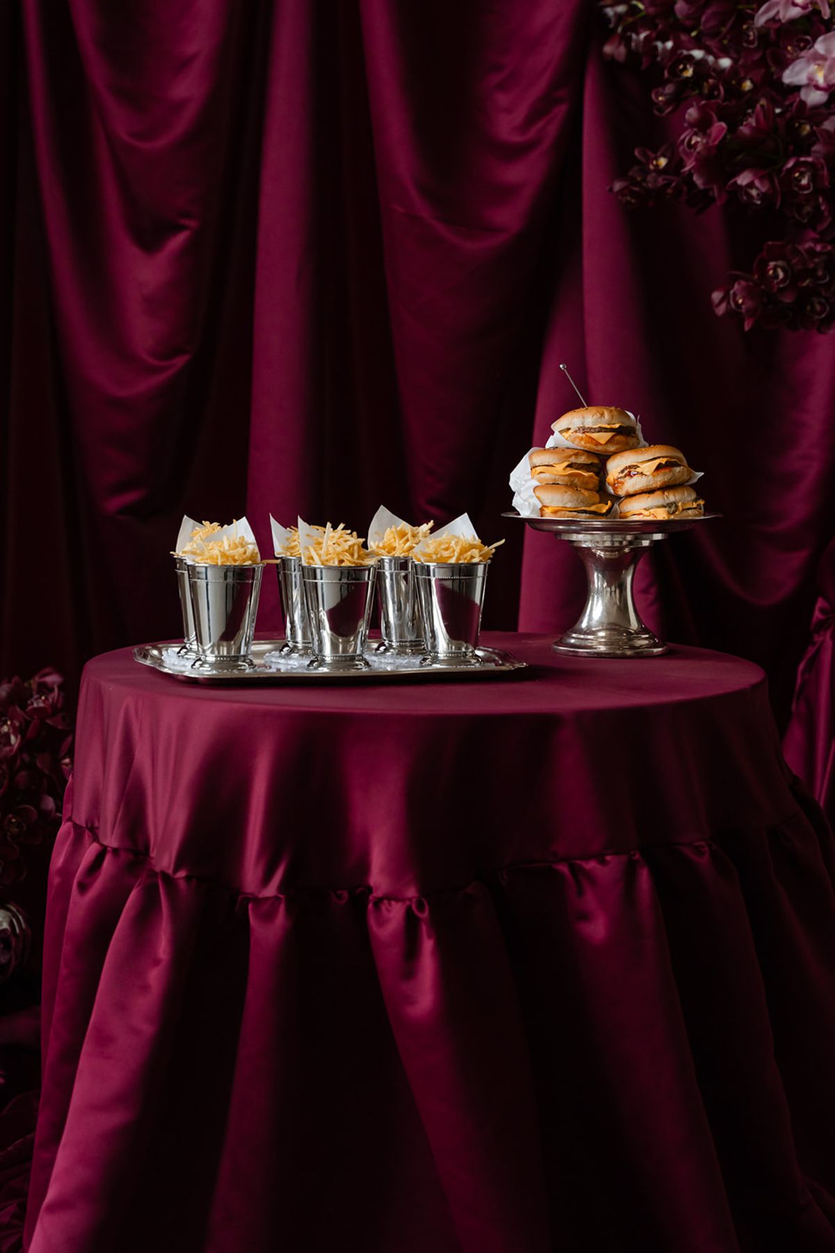 Late-night burgers and fries station on magenta table at Domaine des Halles